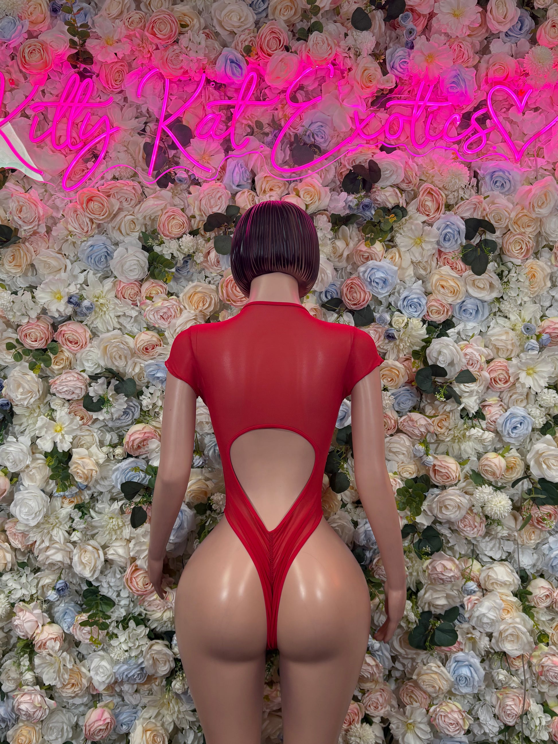 Red one-piece rave bodysuit with open back keyhole and high-cut leg openings