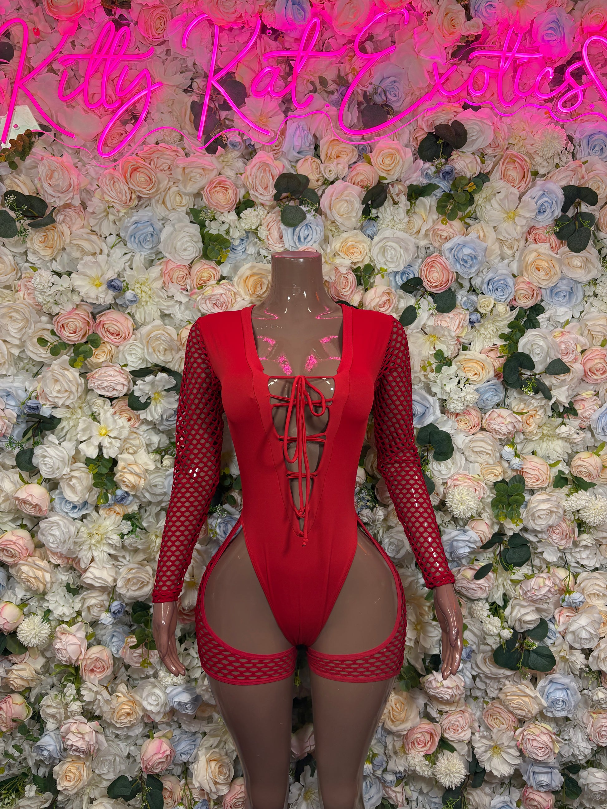 Red lace-up front bodysuit with mesh long sleeves and high-cut garter-style bottoms