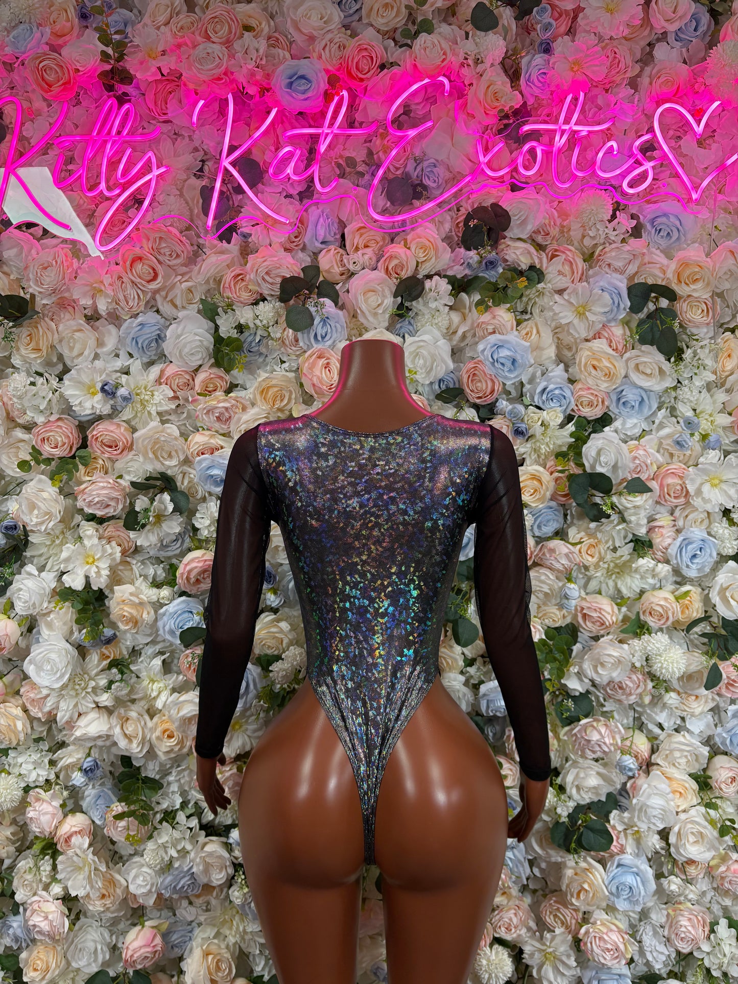 Black metallic bodysuit with long sleeves, scoop front cutout, high-cut leg