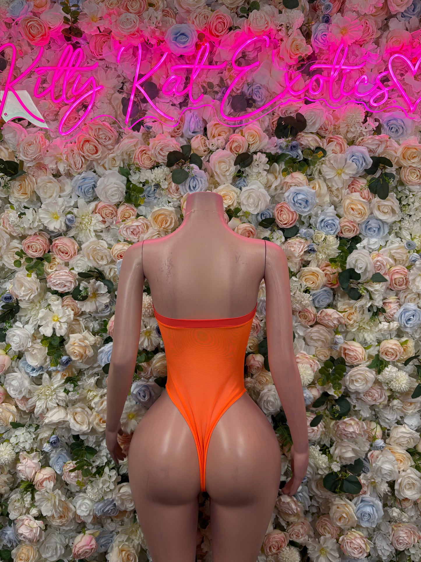 Orange one-piece bodysuit, open-back design with red zipper detail