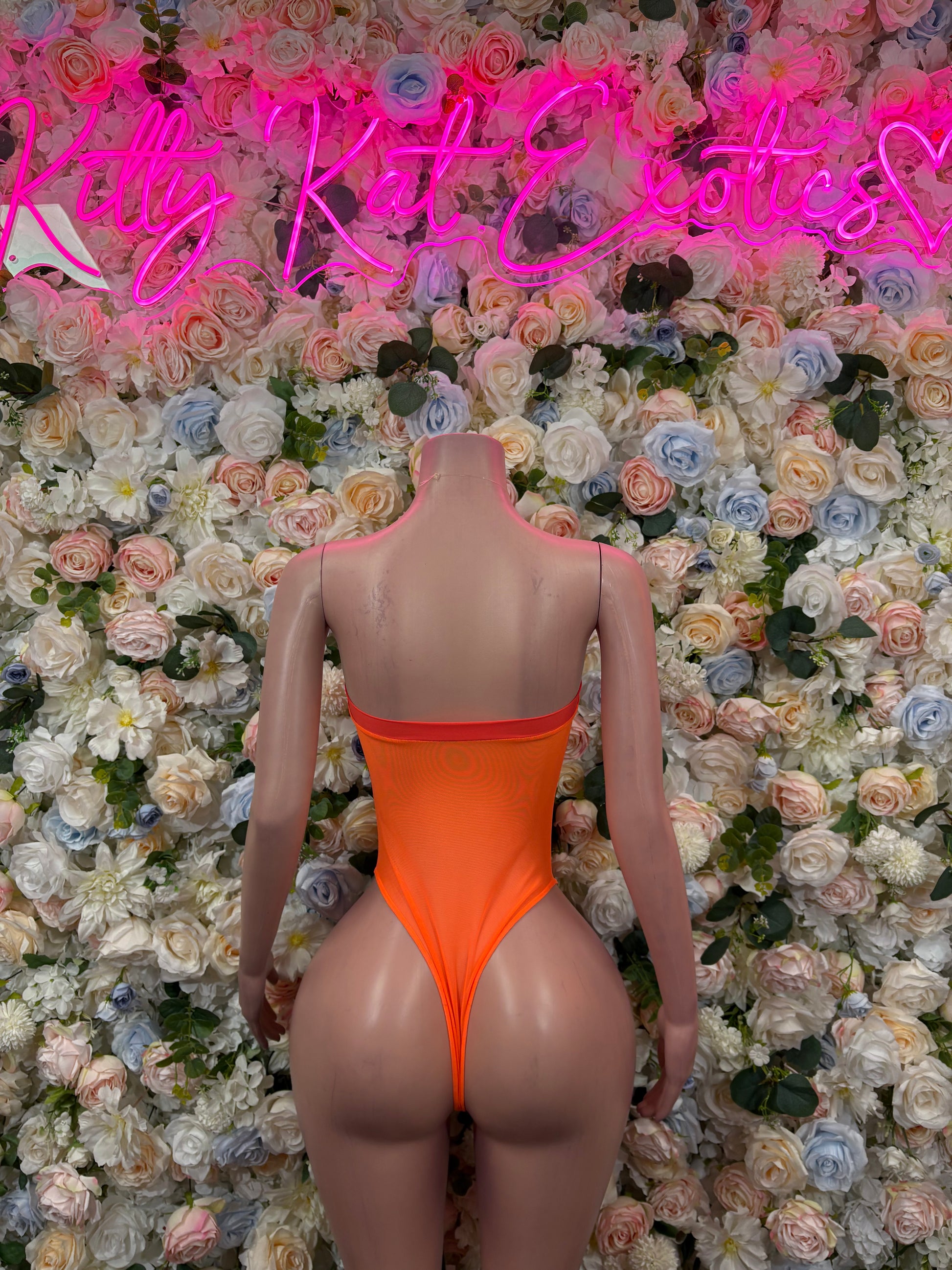 Orange one-piece bodysuit, open-back design with red zipper detail