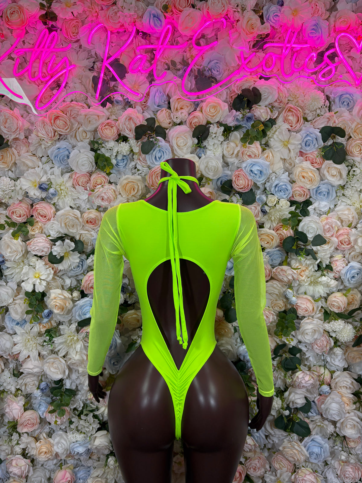 Neon green long-sleeve bodysuit with black teardrop chest cutout and thong back