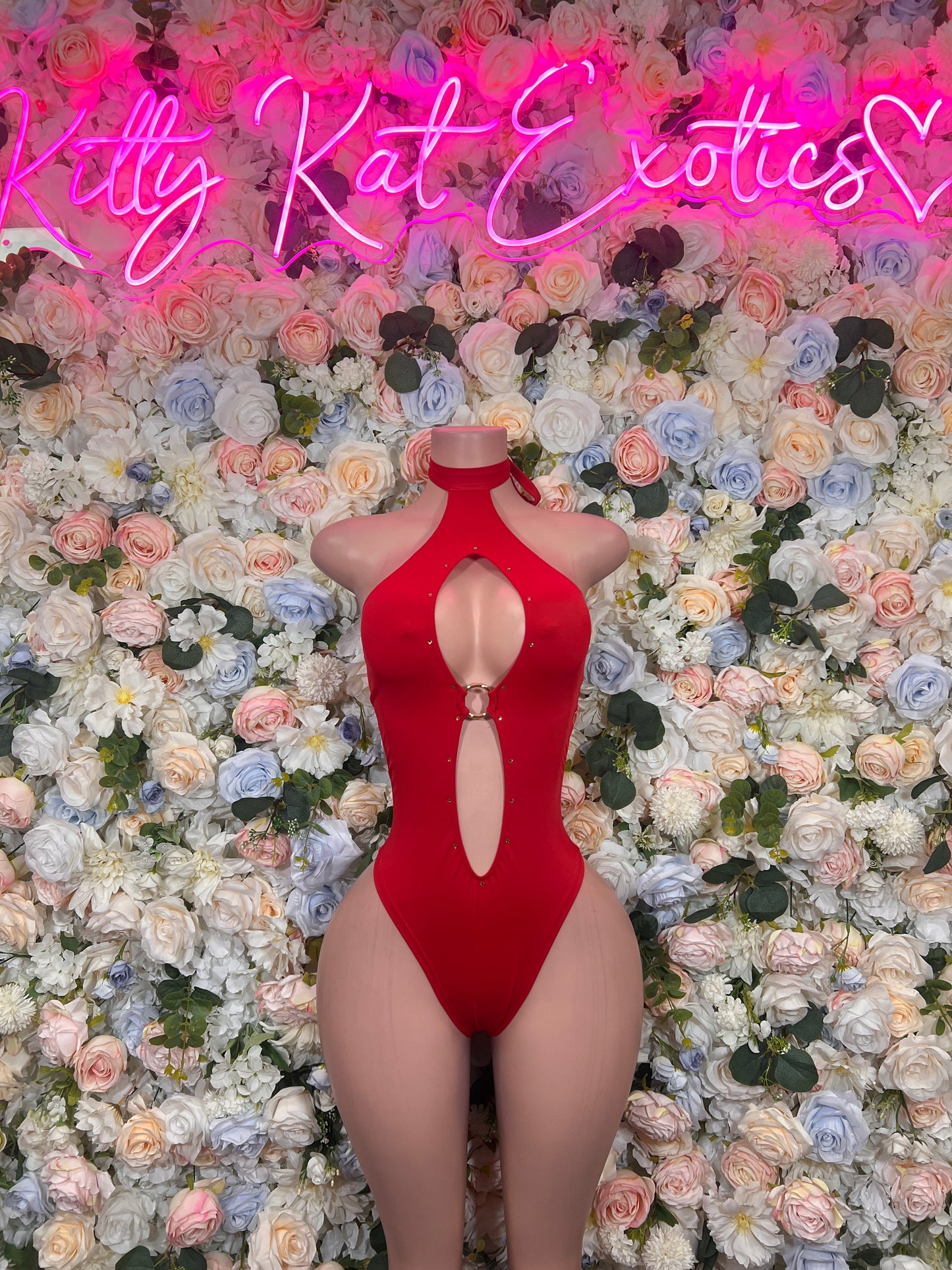 Red halter one-piece bodysuit with deep oval chest cutout and cheeky leg