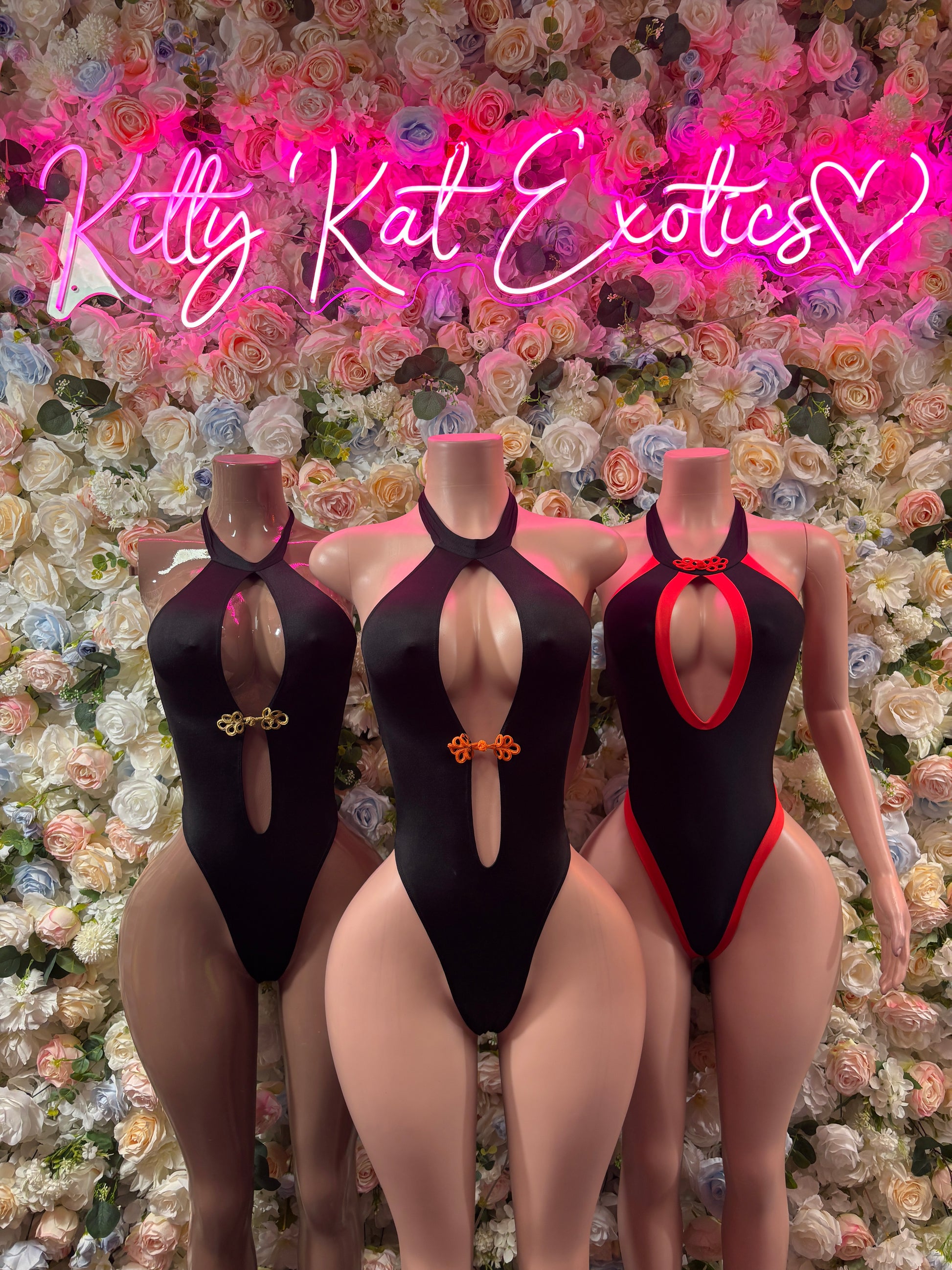 Black halter one-piece bodysuit with oval front cutout and high-cut legs; 3 models shown