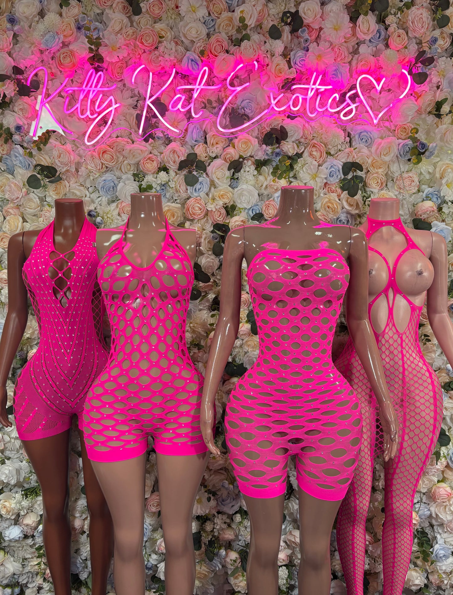 Hot pink fishnet strapless romper with rhinestone-look detailing and cutout back