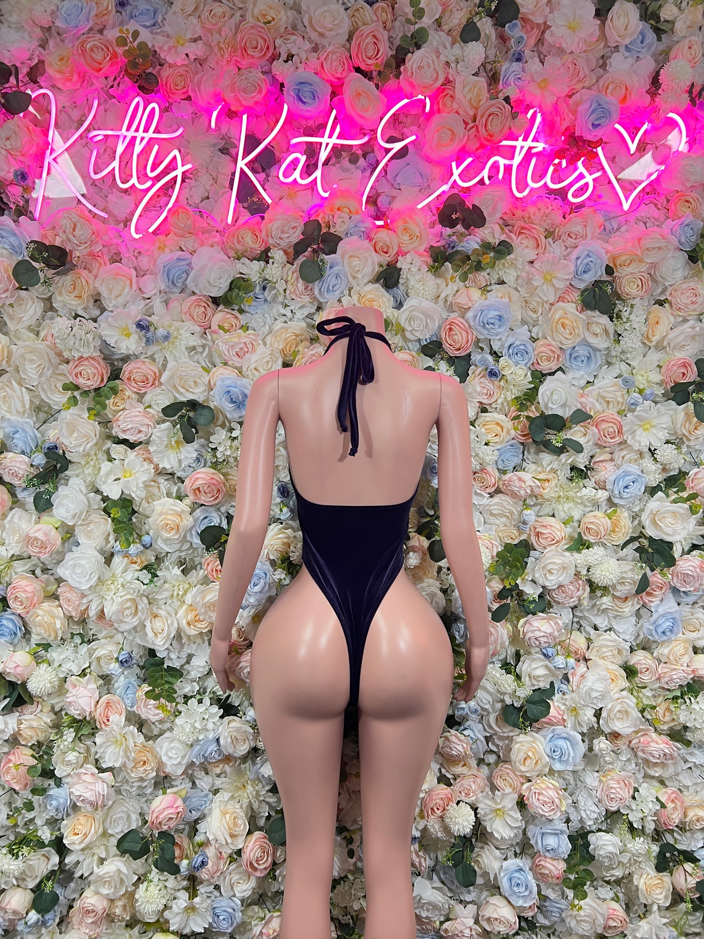 Dark blue one-piece bodysuit with neck tie bow, open back, teardrop chest cutouts