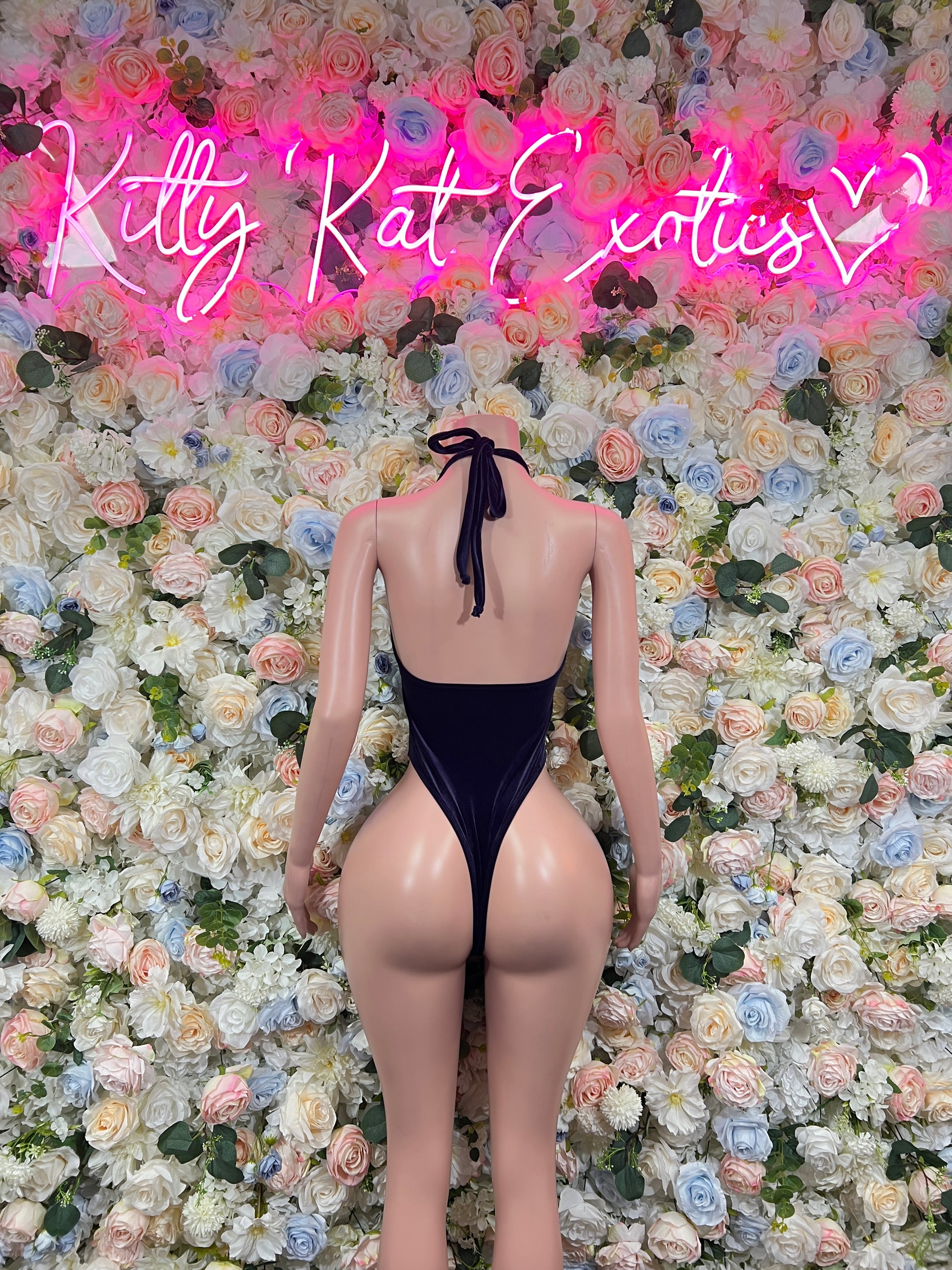 Dark blue one-piece bodysuit with neck tie bow, open back, teardrop chest cutouts