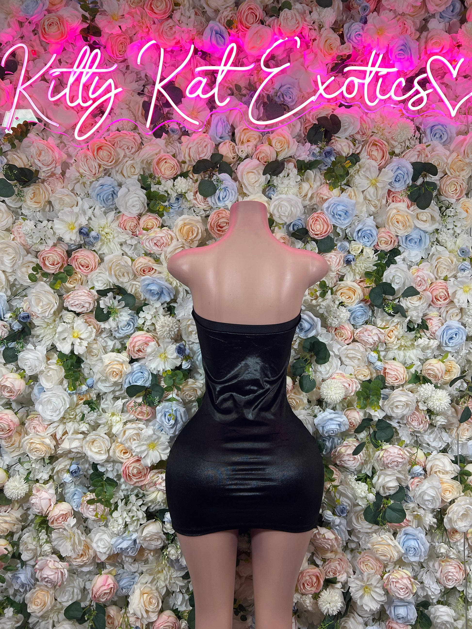 Black satin mini dress, backless strapless style with corset seams, mannequin back view