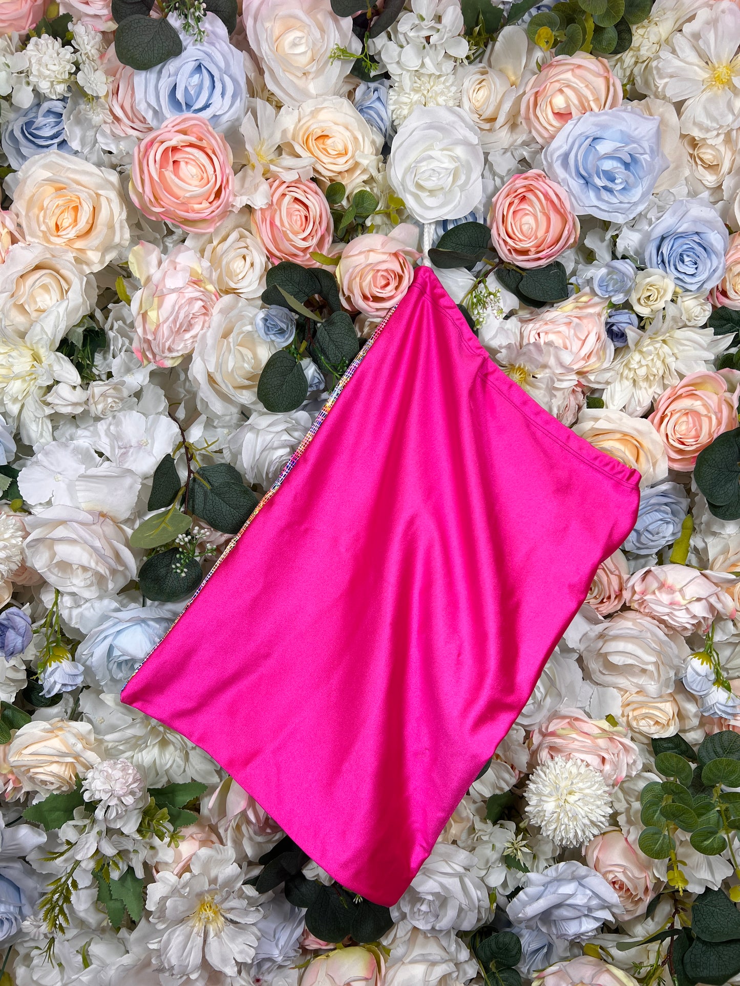 Hot pink slouchy pouch bag with pointed bottom and no visible handle