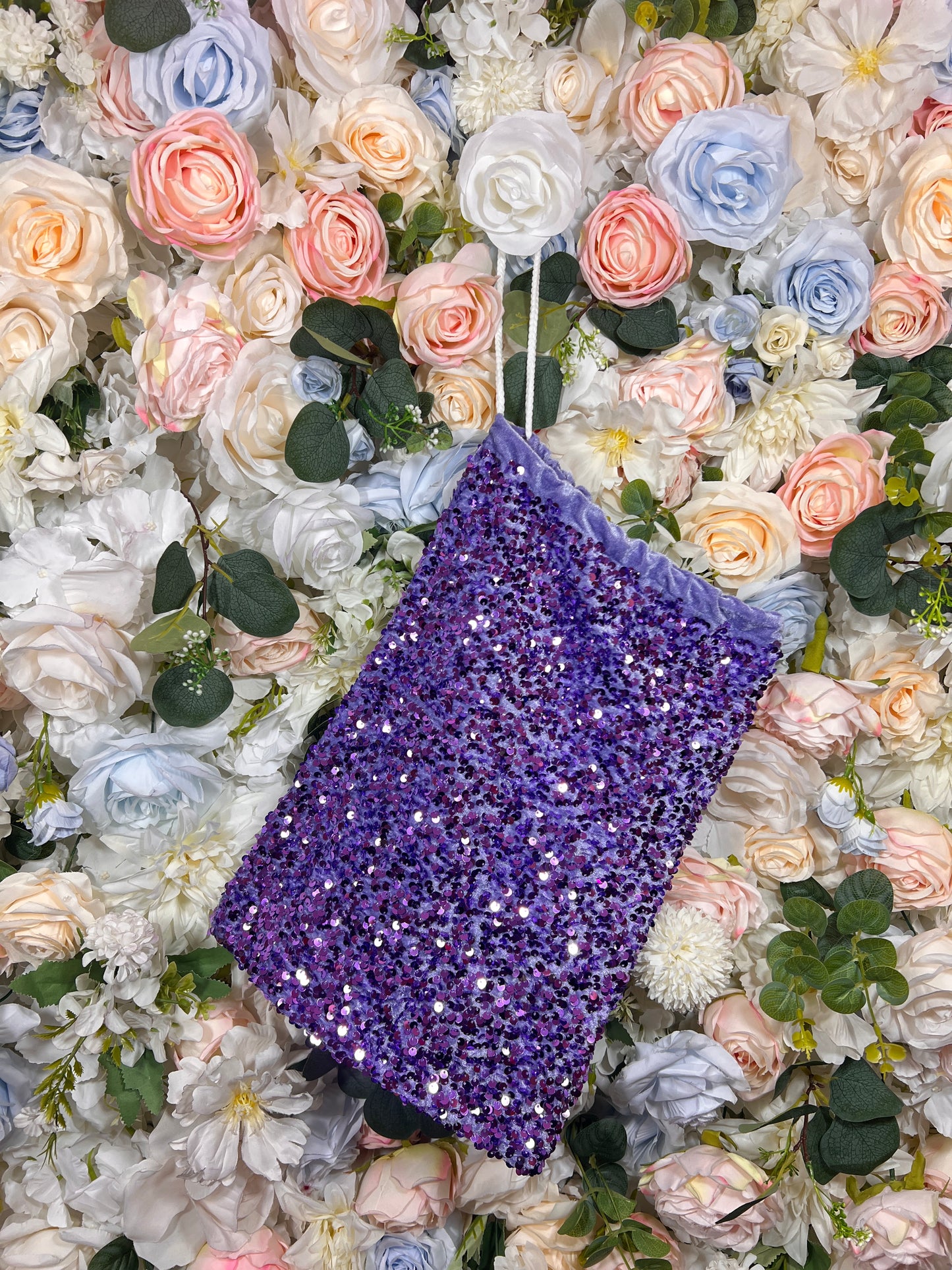 Purple sequined velvet money bag, angled view with short handle