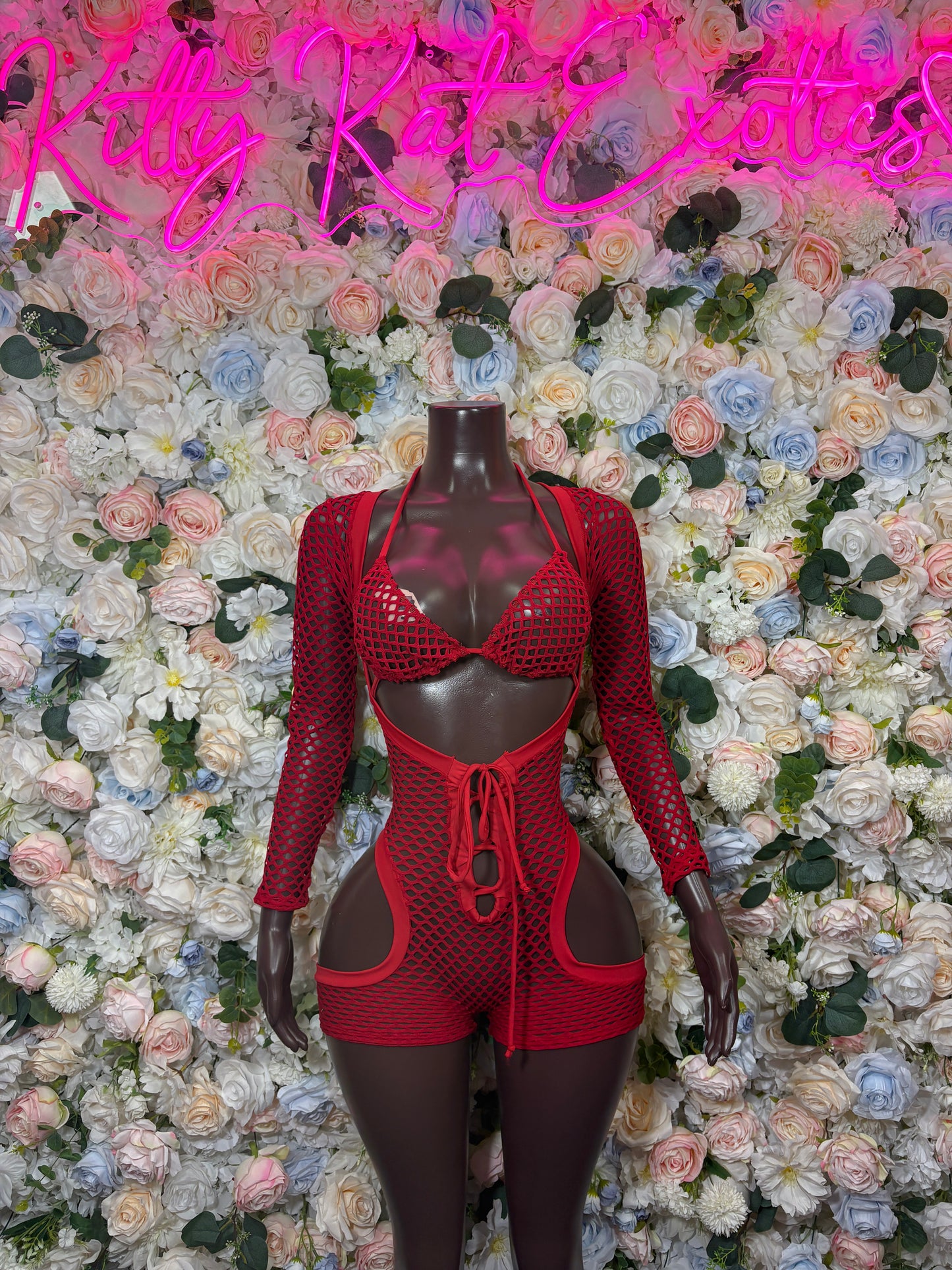 Red fishnet bodysuit with long sleeves, chest cutouts, and tied waist keyhole