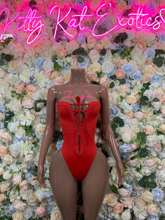 Red corset-style bodysuit with front lace-up and bow ribbon, high-cut