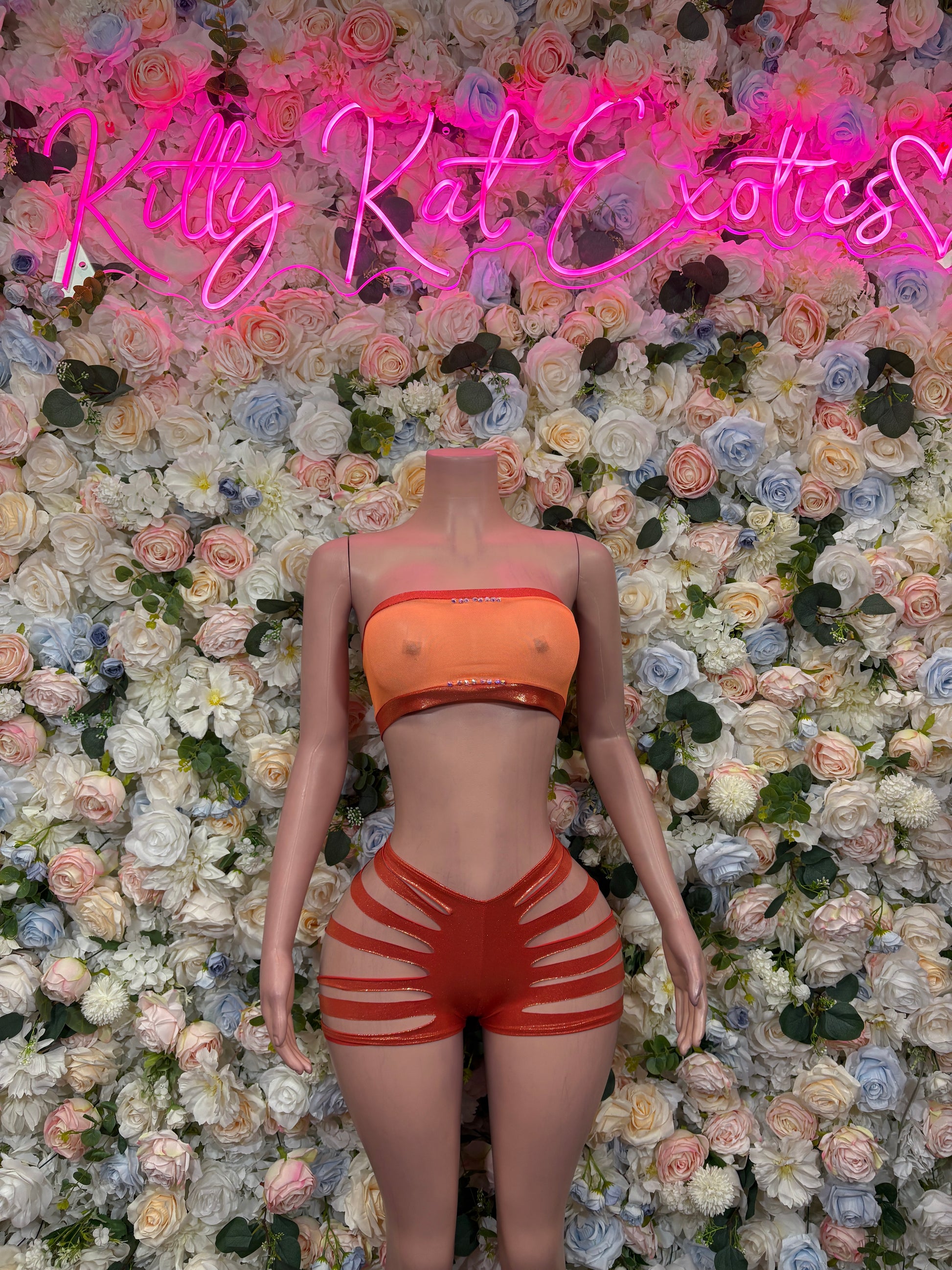 Orange bandeau top and striped high-waist shorts, back view
