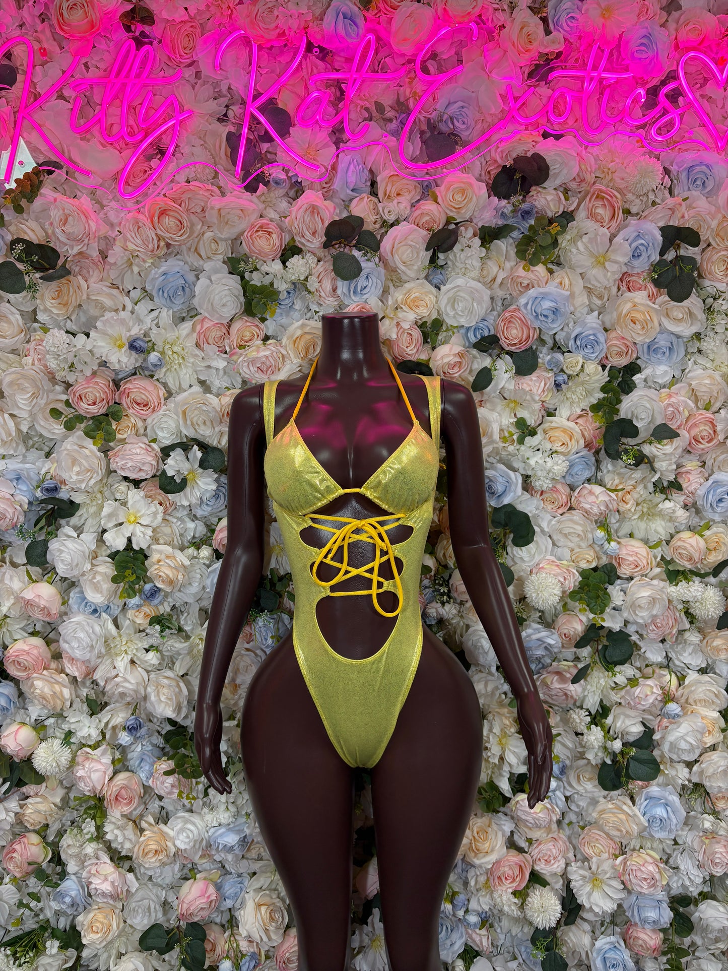 Yellow metallic sleeveless bodysuit with lace-up neckline and high-cut legs