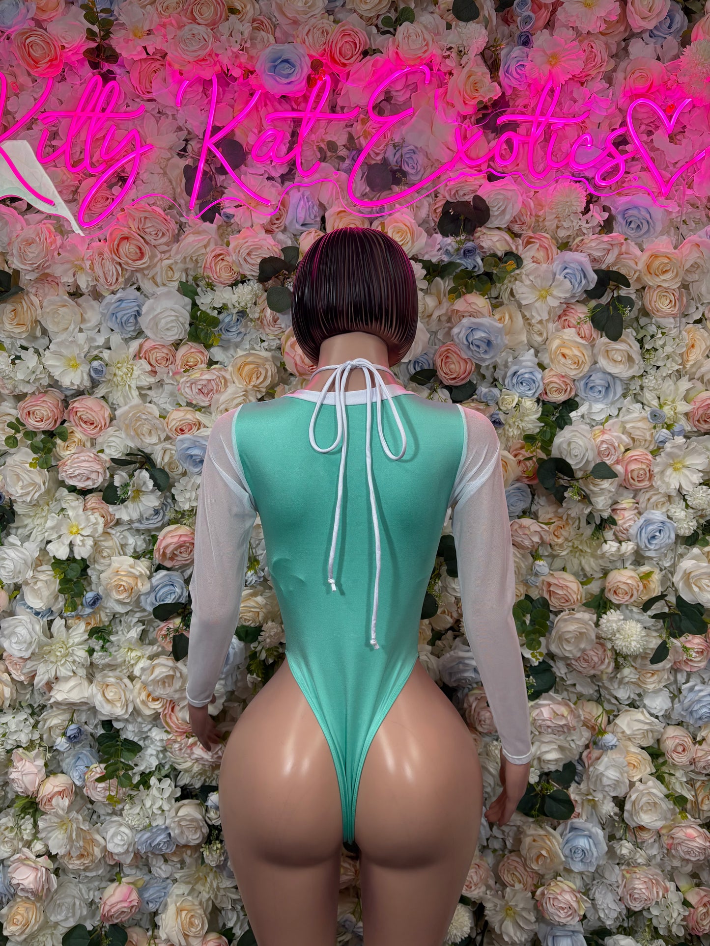 Teal cheetah-print bodysuit back with white tie cords and long sheer sleeves