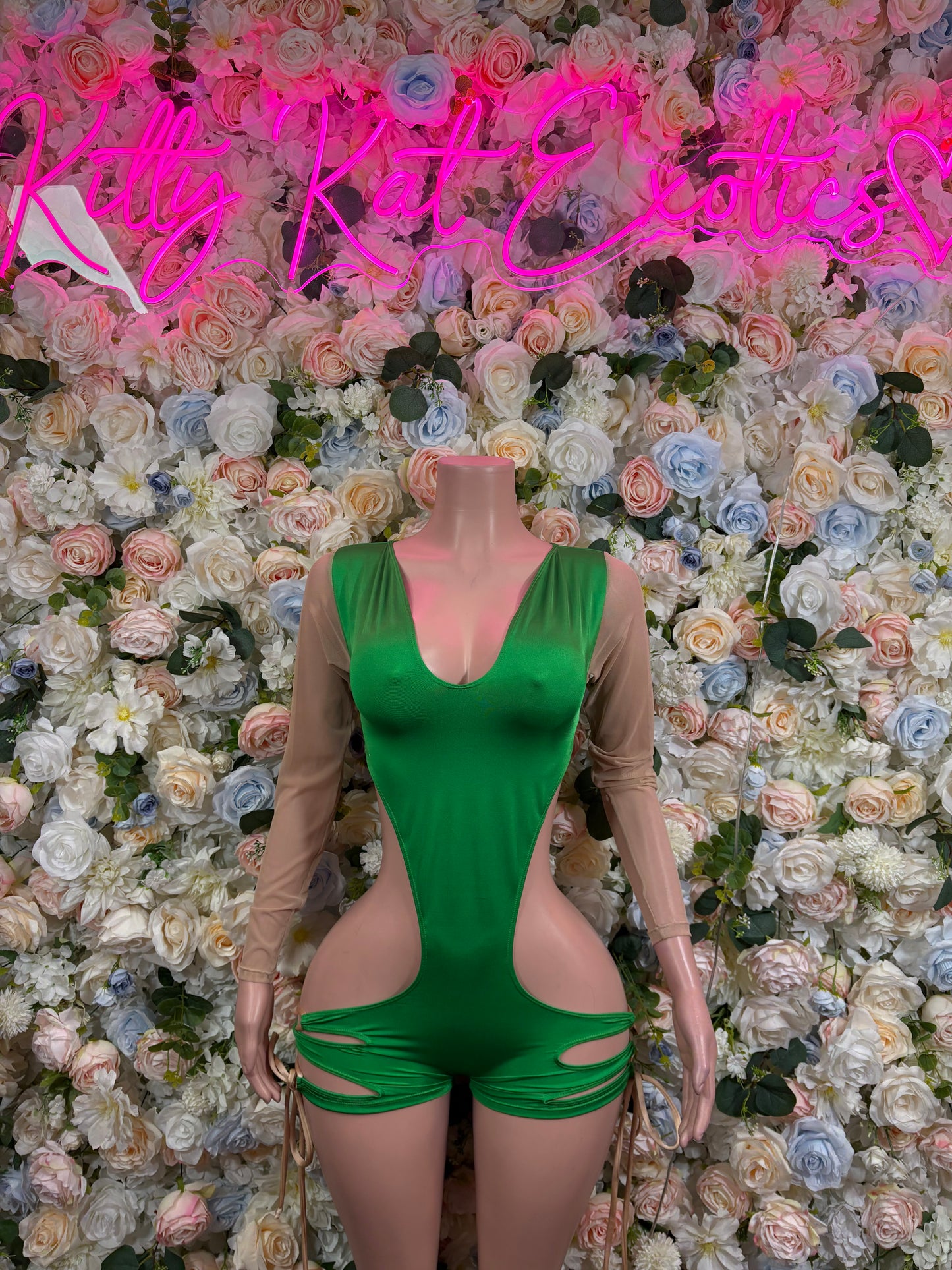 Green mesh bodysuit with deep V neckline, ruched hip cutouts, long sheer sleeves