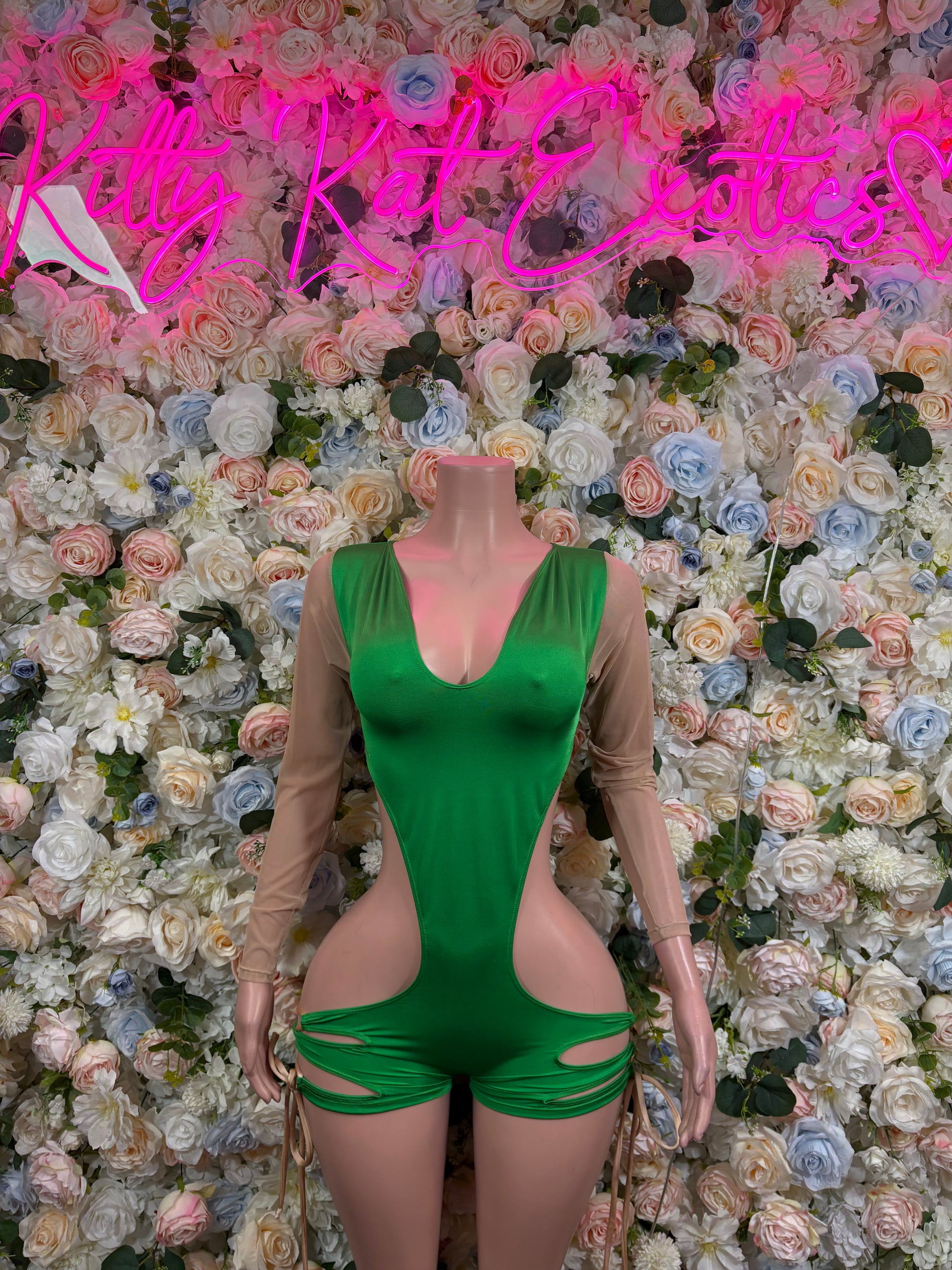 Green mesh bodysuit with deep V neckline, ruched hip cutouts, long sheer sleeves