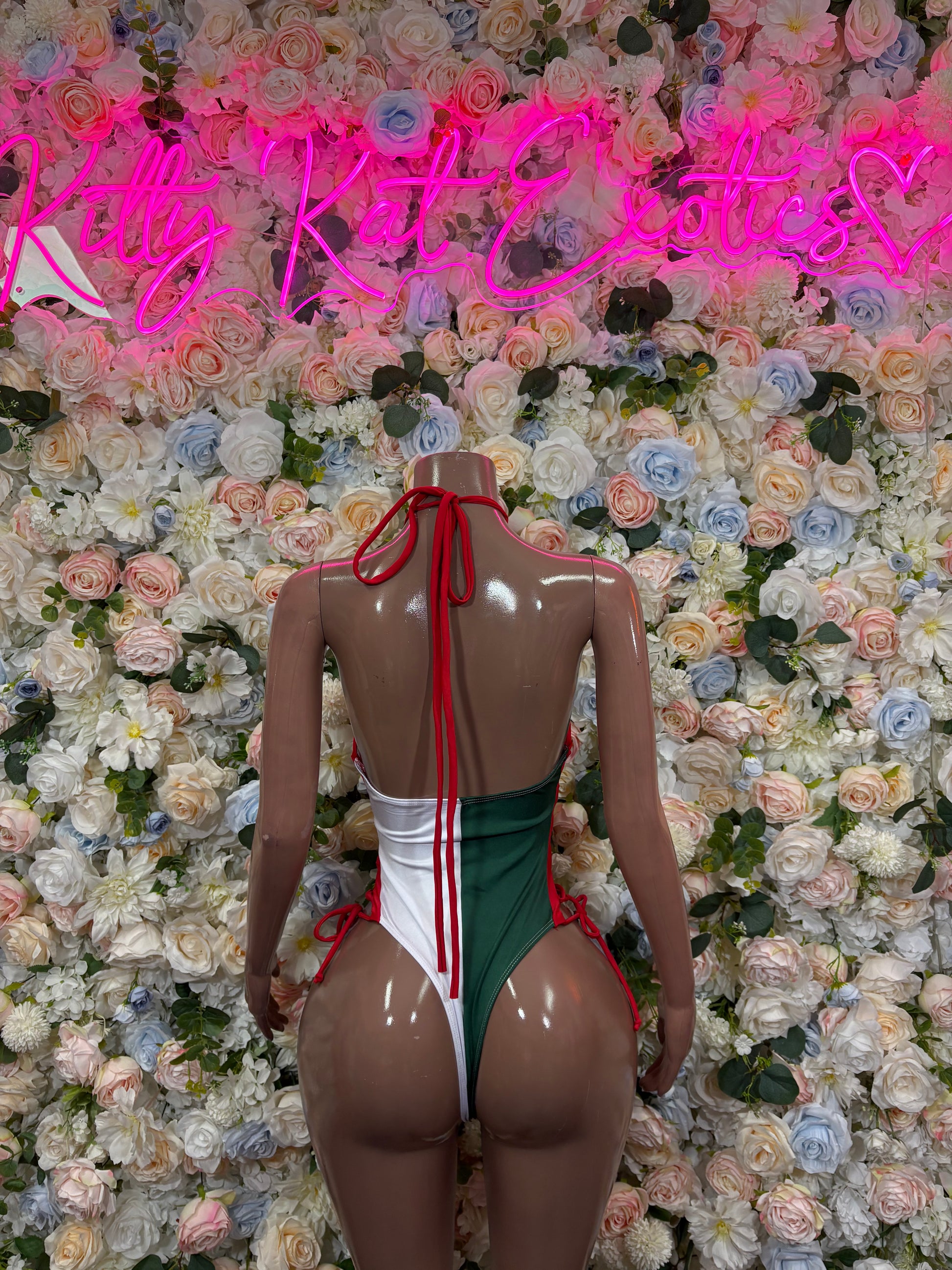 Women’s green & white bodysuit with red tie strings and open back