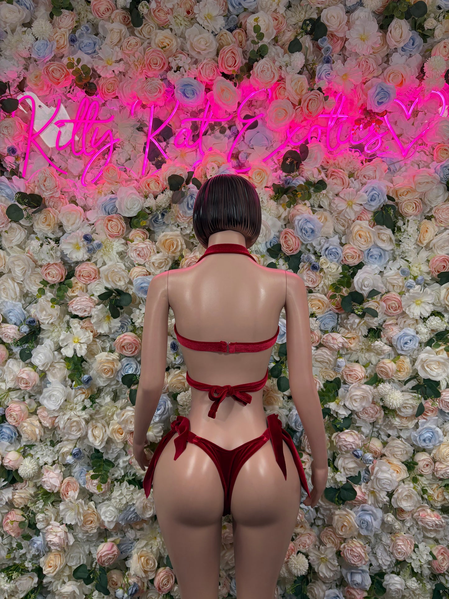 Red velvet two-piece back view with halter straps and high-cut thong bottoms
