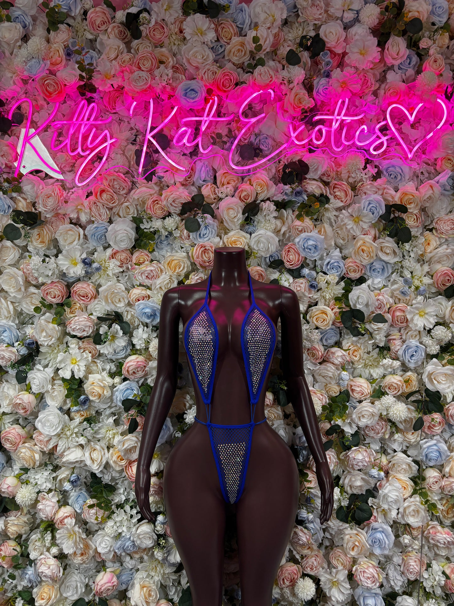 Blue fishnet bodysuit with slingshot cut, front view
