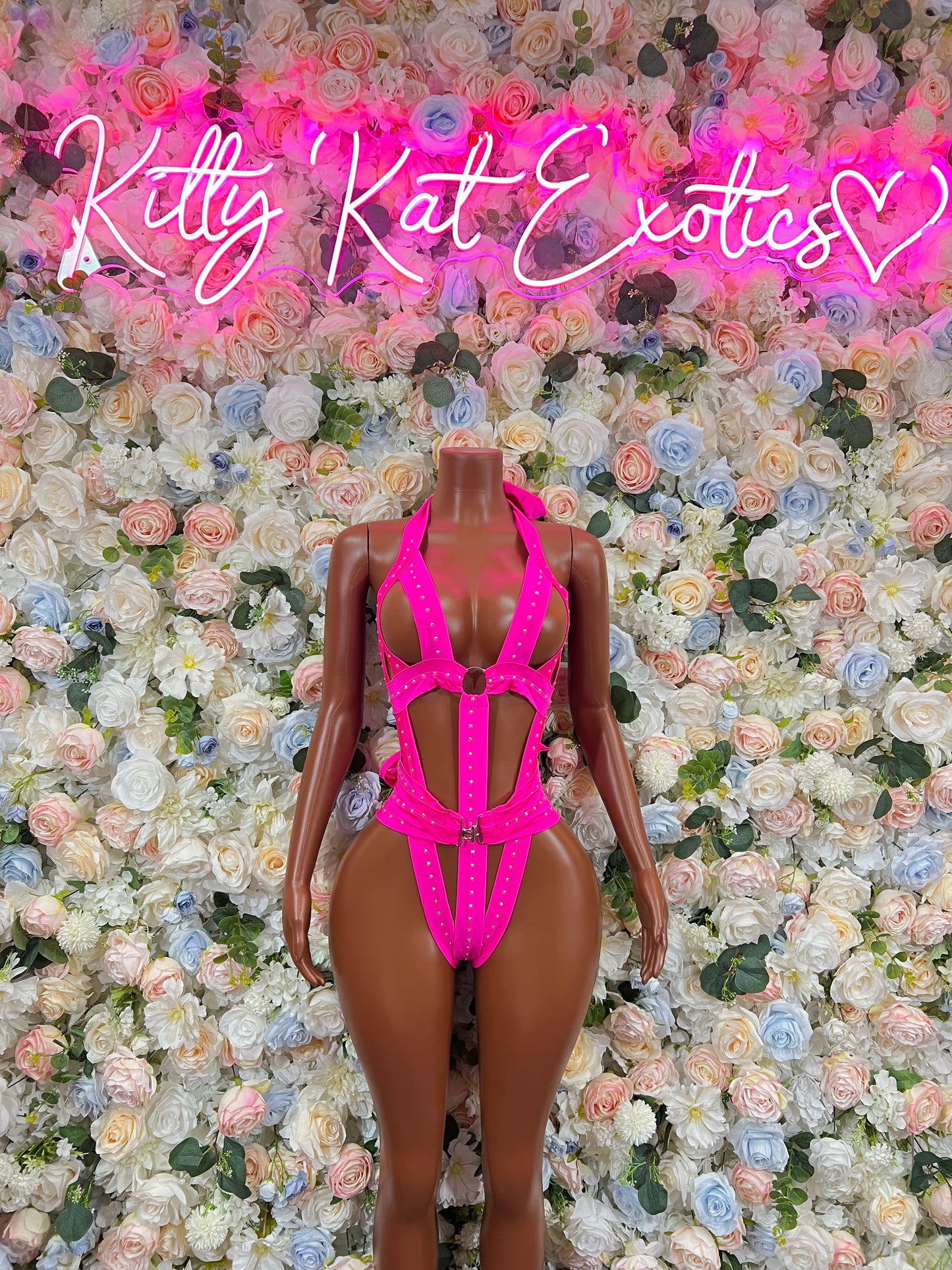 Pink strappy bodysuit with high-cut legs and front cutout