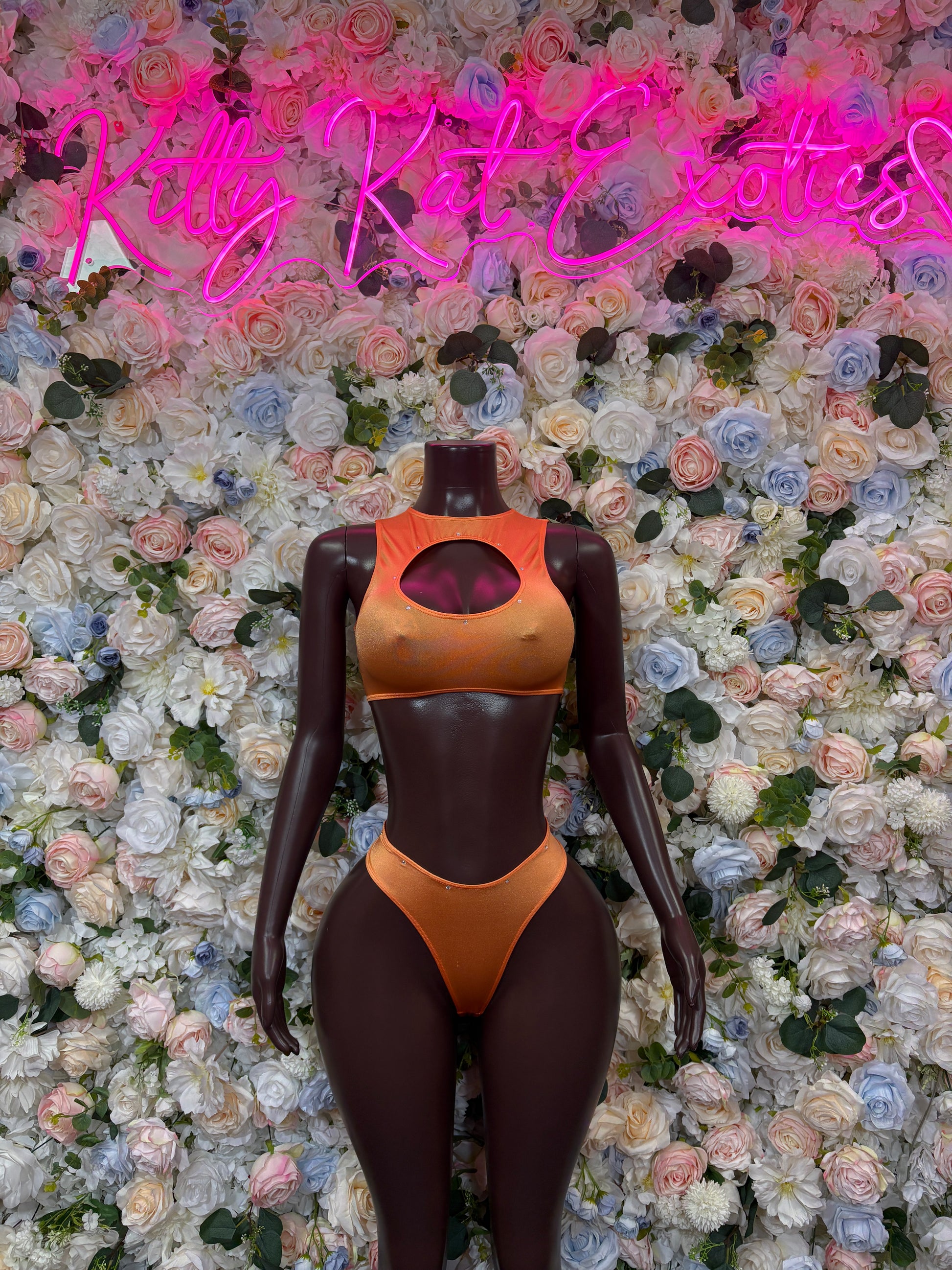 Two-piece orange cutout swimsuit with halter top and high-cut bottoms, front view
