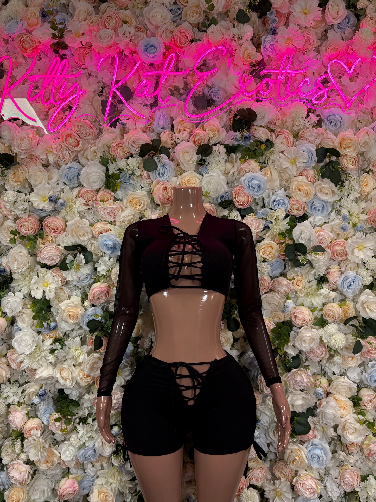 Black lace-up bodysuit with long sleeves and high-cut shorts