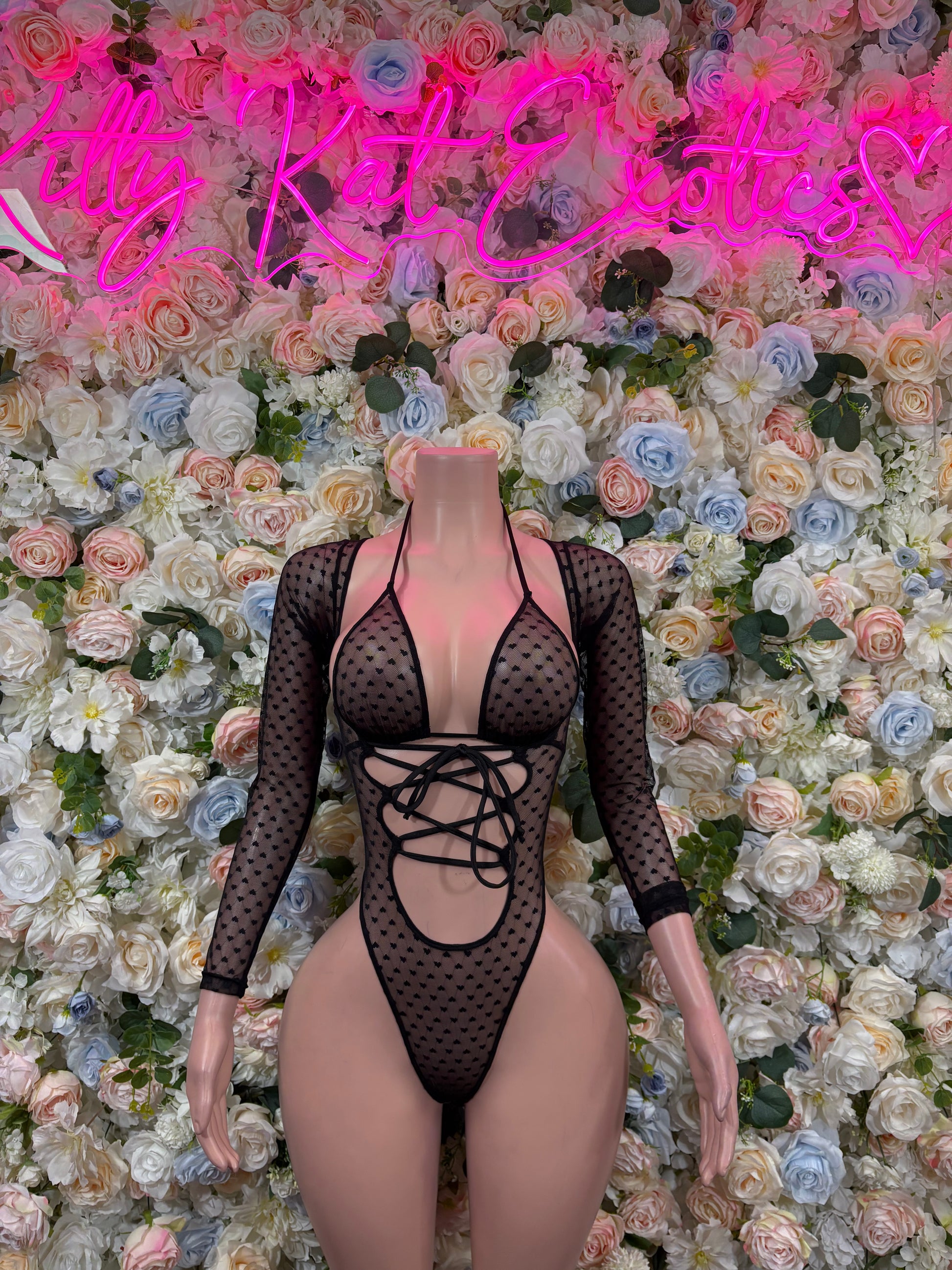 Black heart-pattern mesh bodysuit with long sleeves and crisscross lace-up front