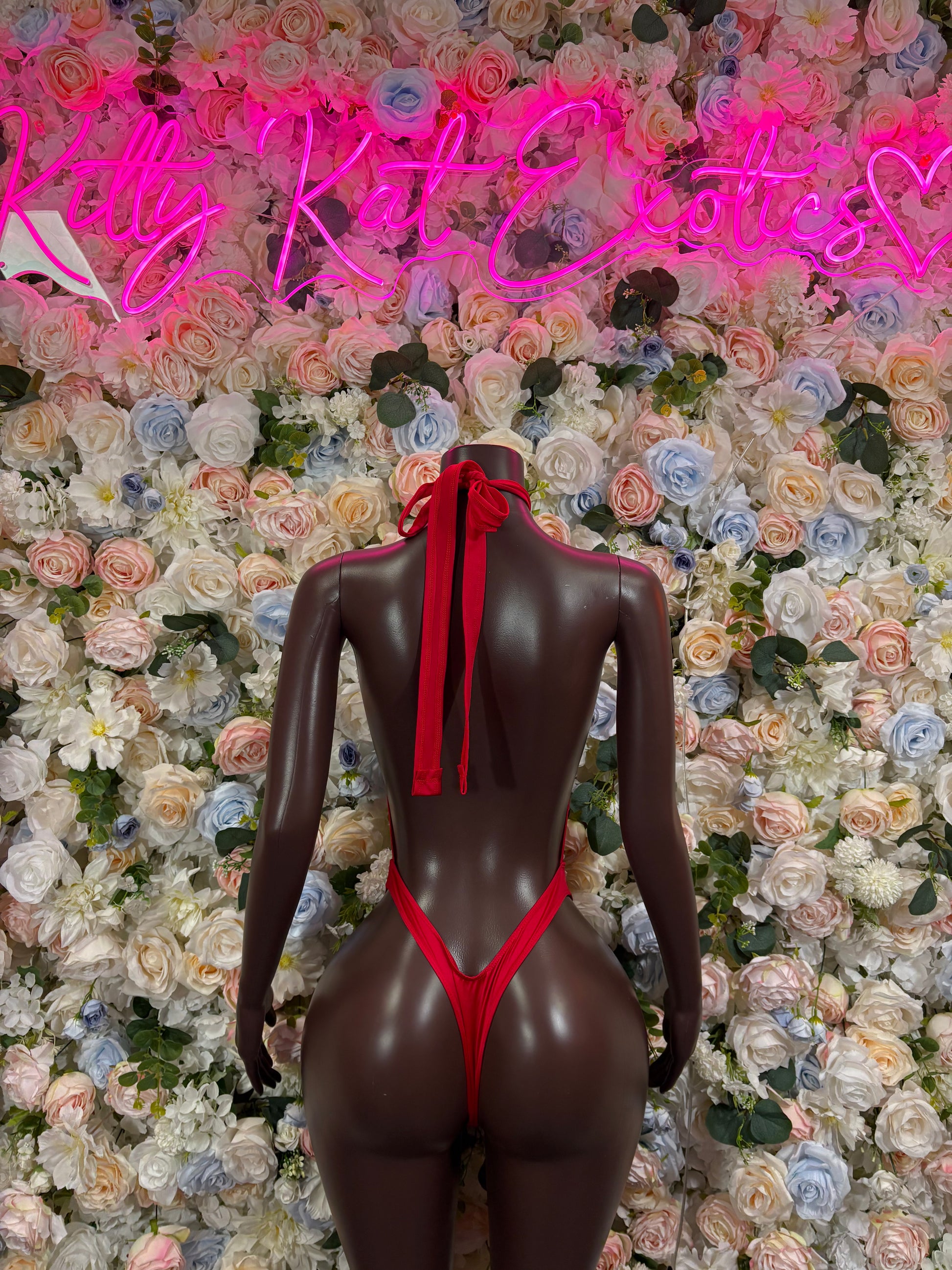 Red open-back bodysuit with center bow tie and cheeky bottom