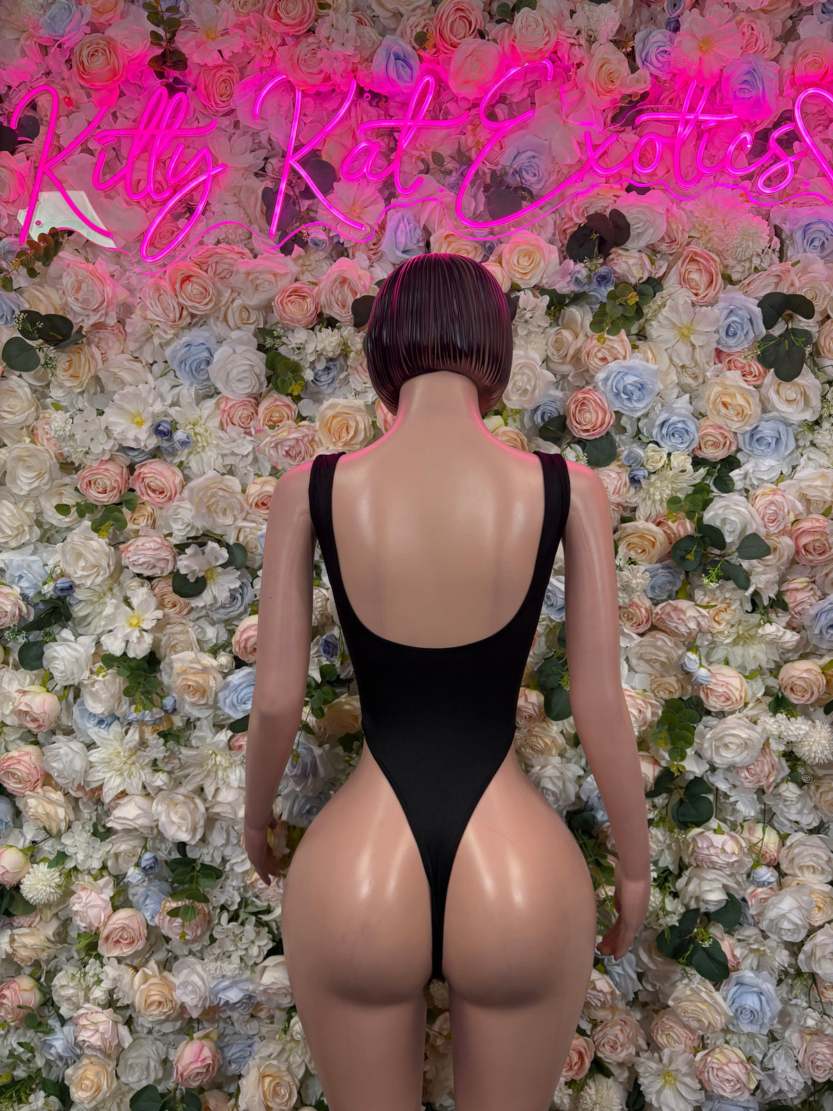 Black one-piece bodysuit with low back and thin shoulder straps