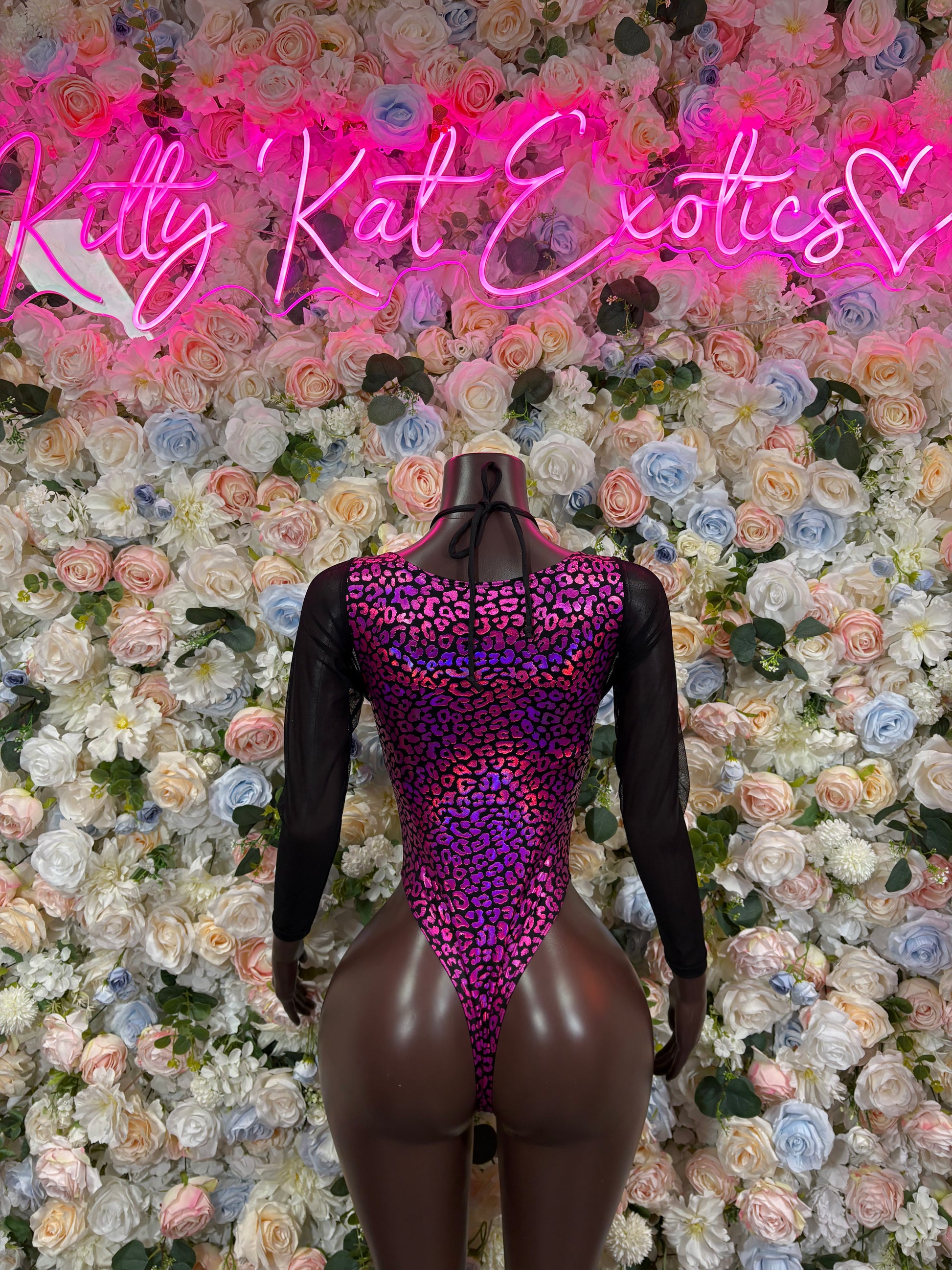 Purple leopard-print one-piece bodysuit with sheer sleeves, strappy lace-up front cutout