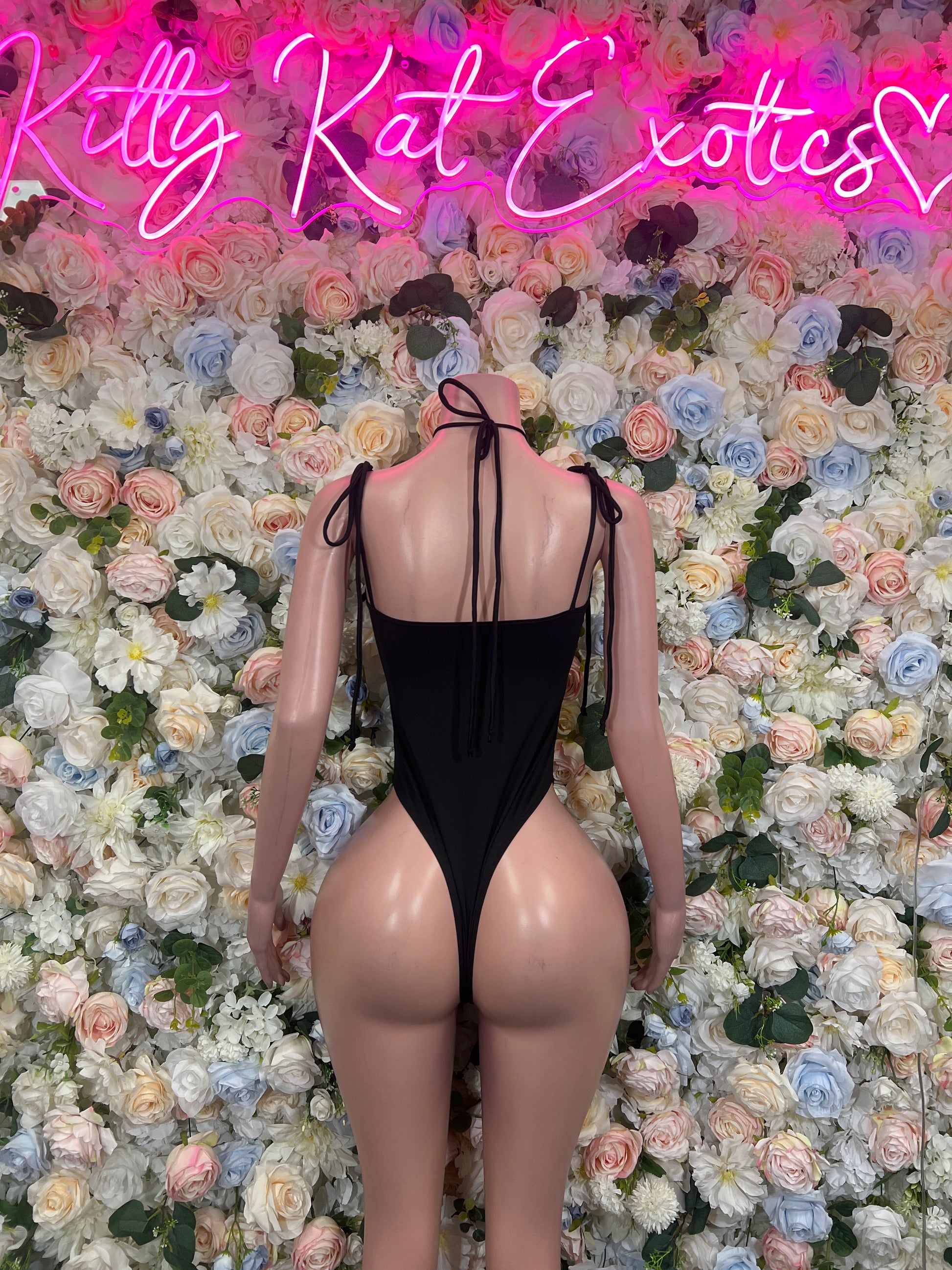 Black lace-back bodysuit with crisscross straps and high-cut back