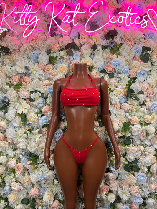 Red string bikini two-piece with ruched crop top and matching string hip bottoms