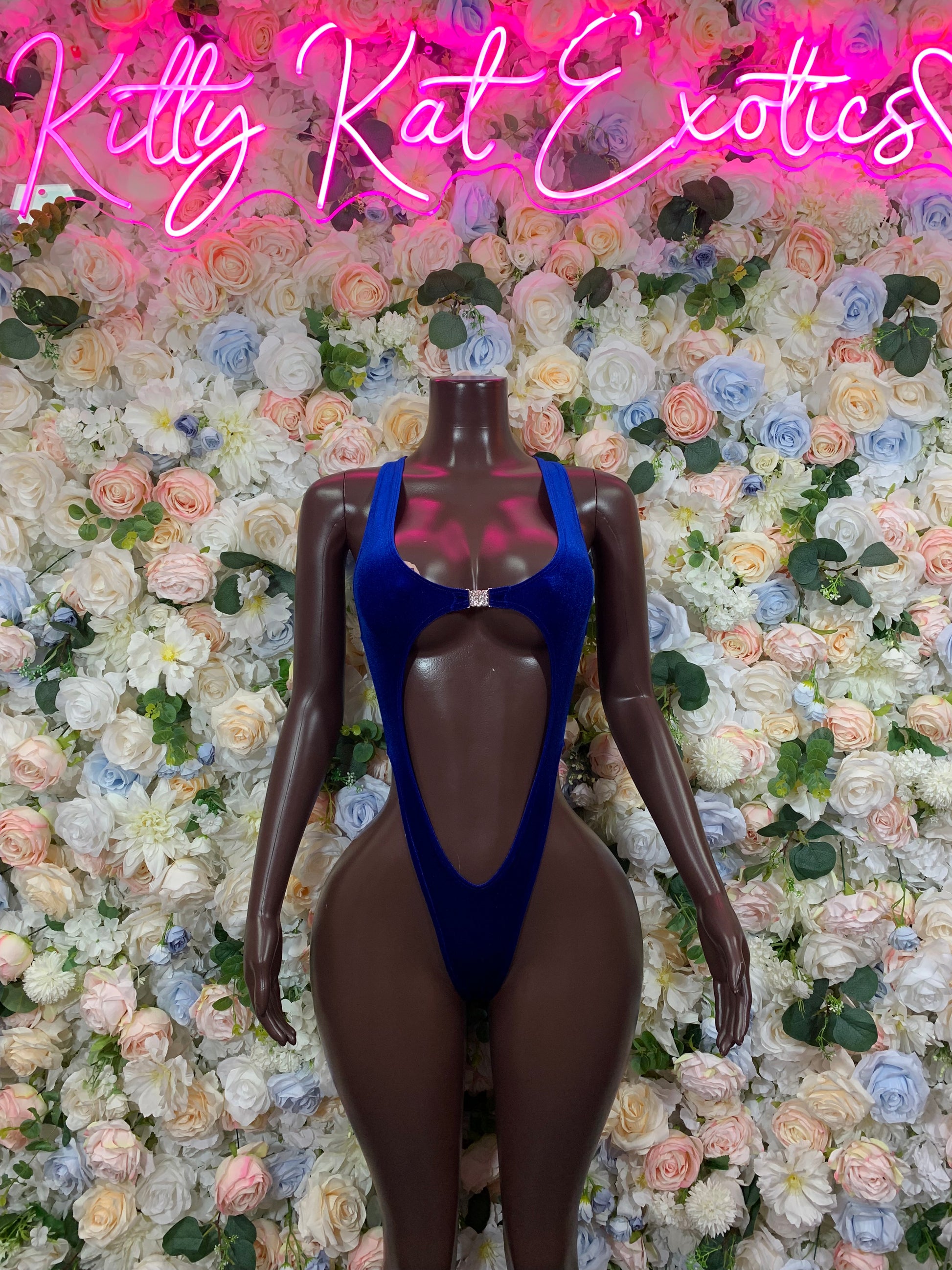 Dark blue velvet one-piece bodysuit with deep front V neckline and crisscross strap back