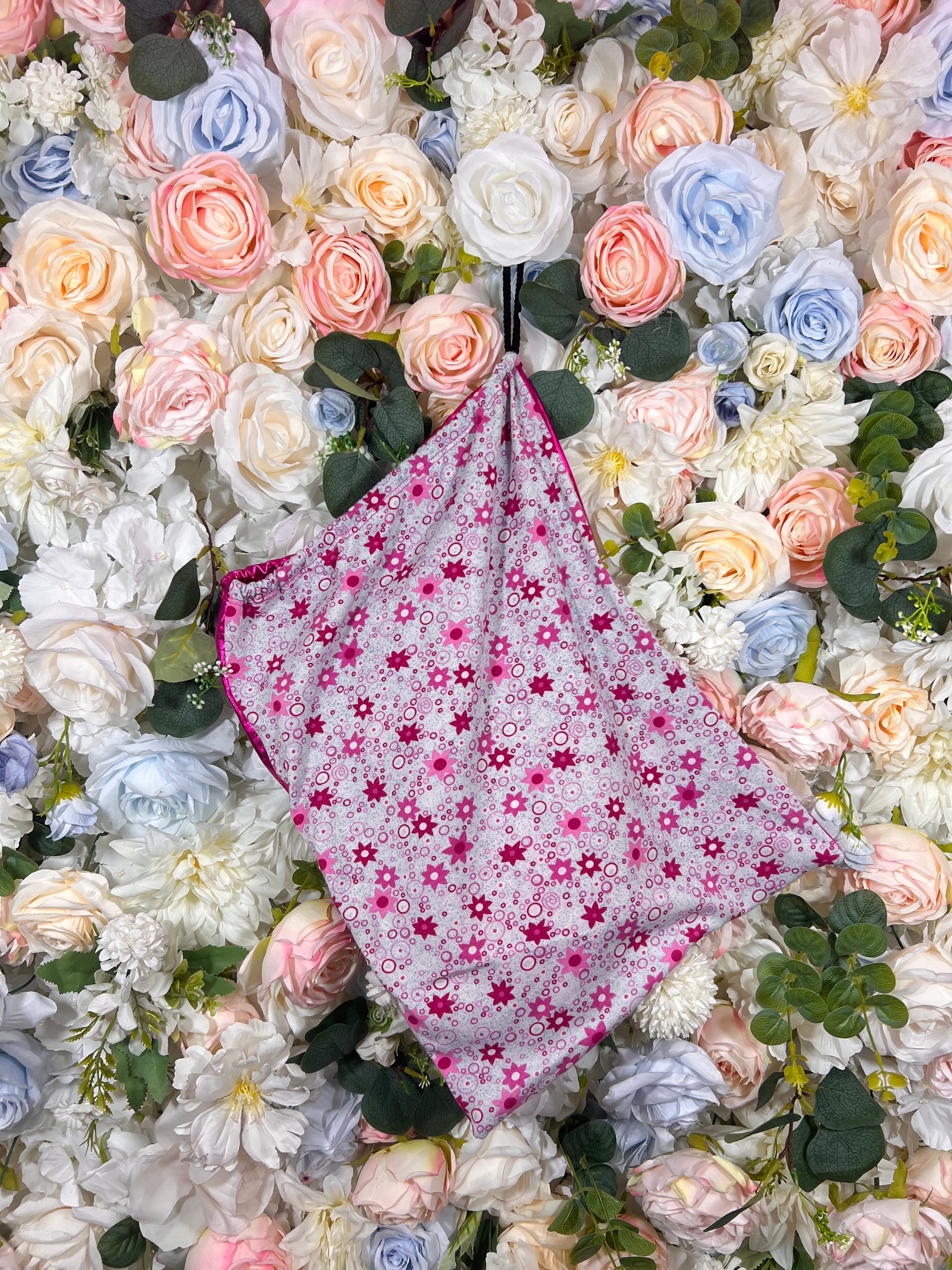 Pink floral drawstring money bag with cinched opening