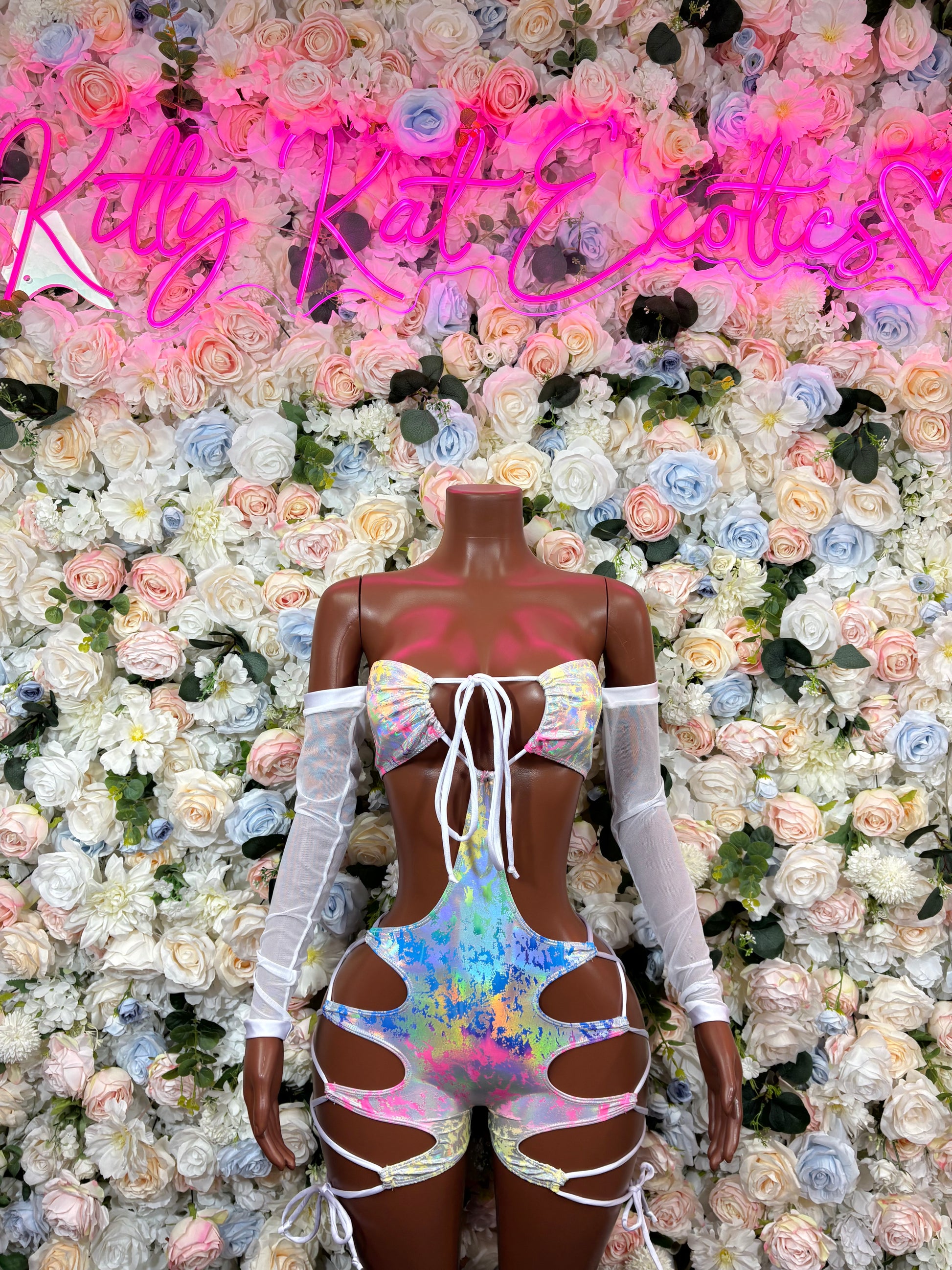 Rainbow hologram one-piece bodysuit with white lace-up straps and sheer sleeves