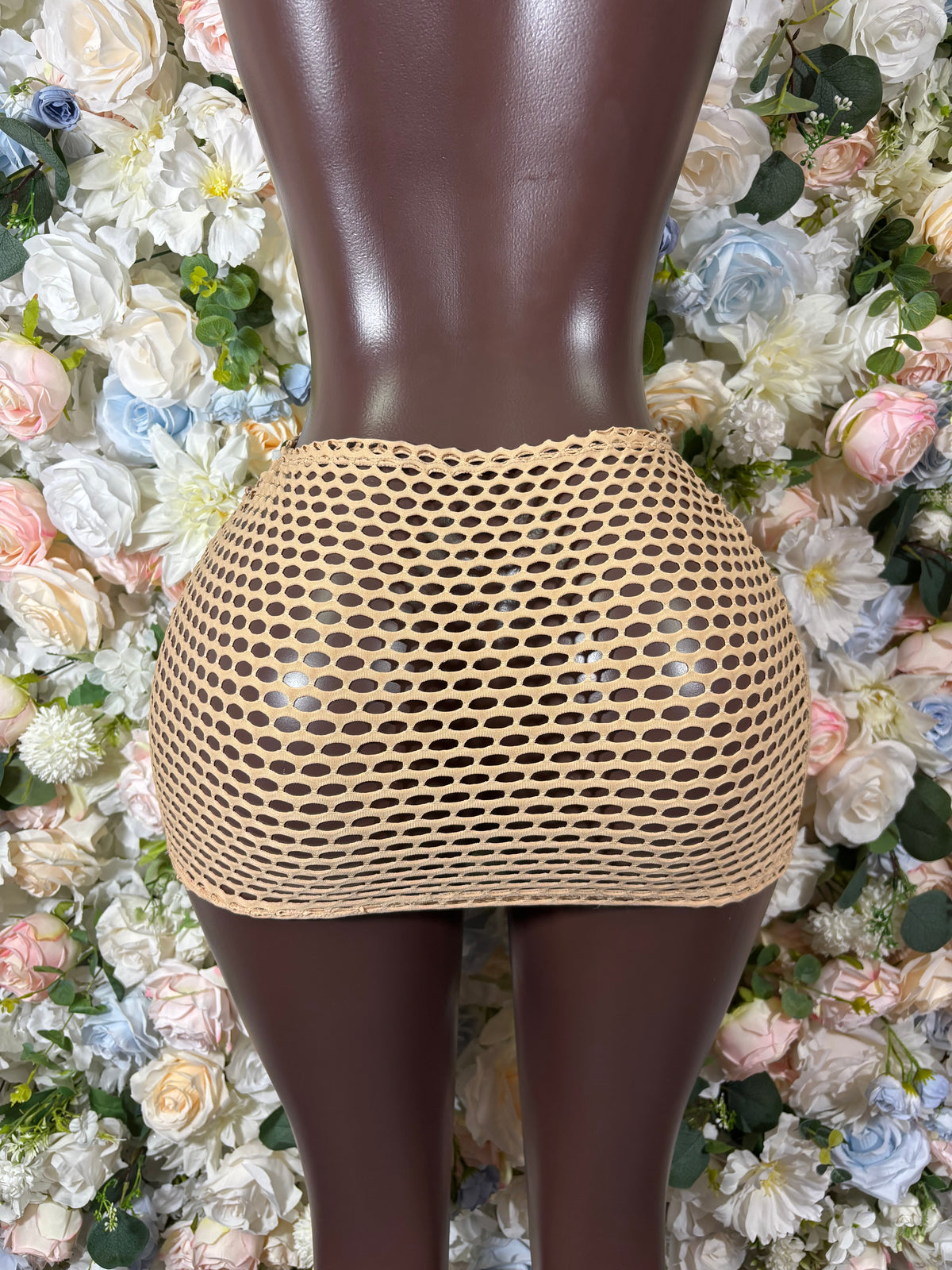 Nude fishnet mini skirt with circular mesh pattern, straight waist and hem