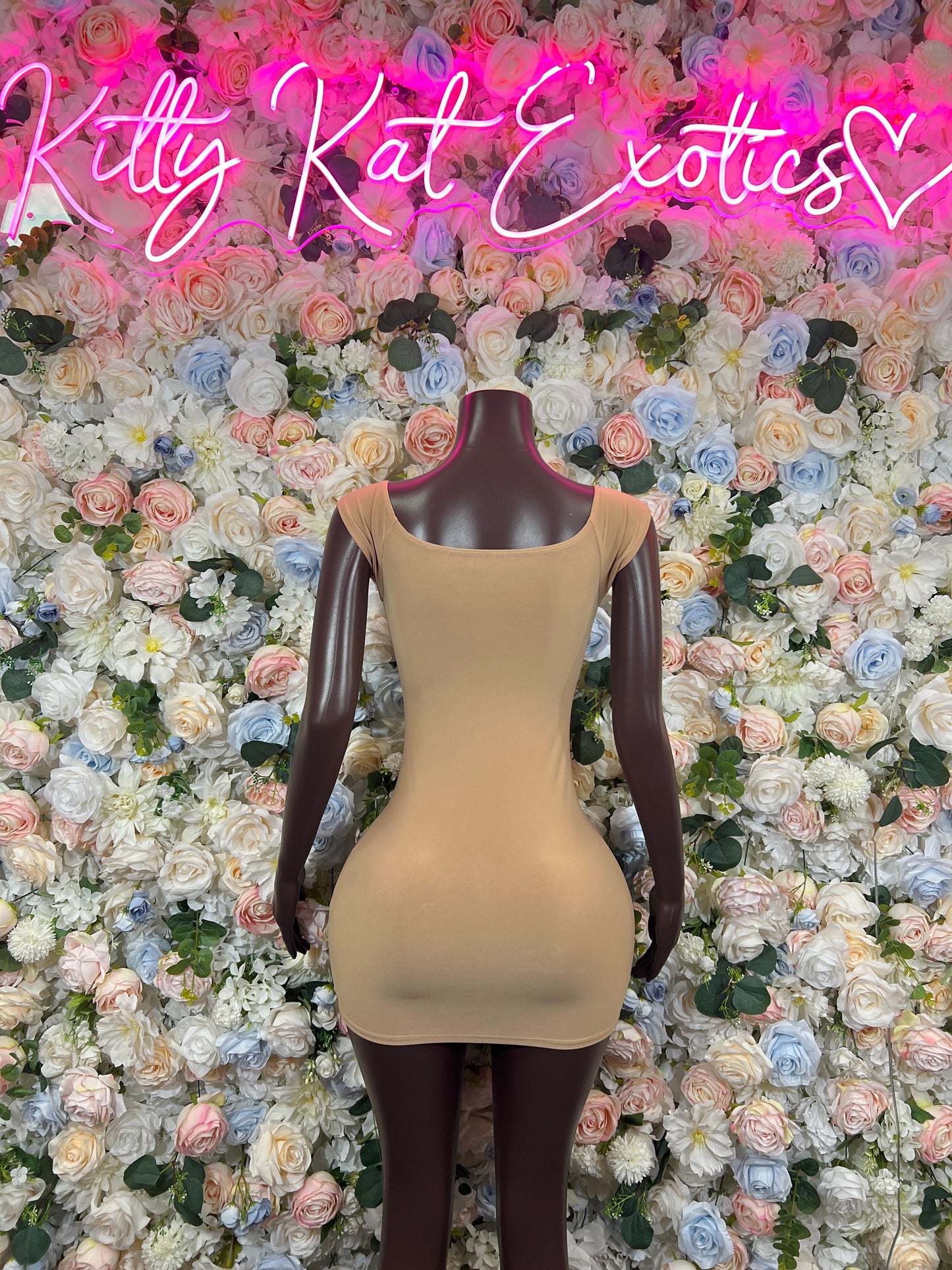 Nude sleeveless mini dress, fitted silhouette, scoop neck, corset-style front