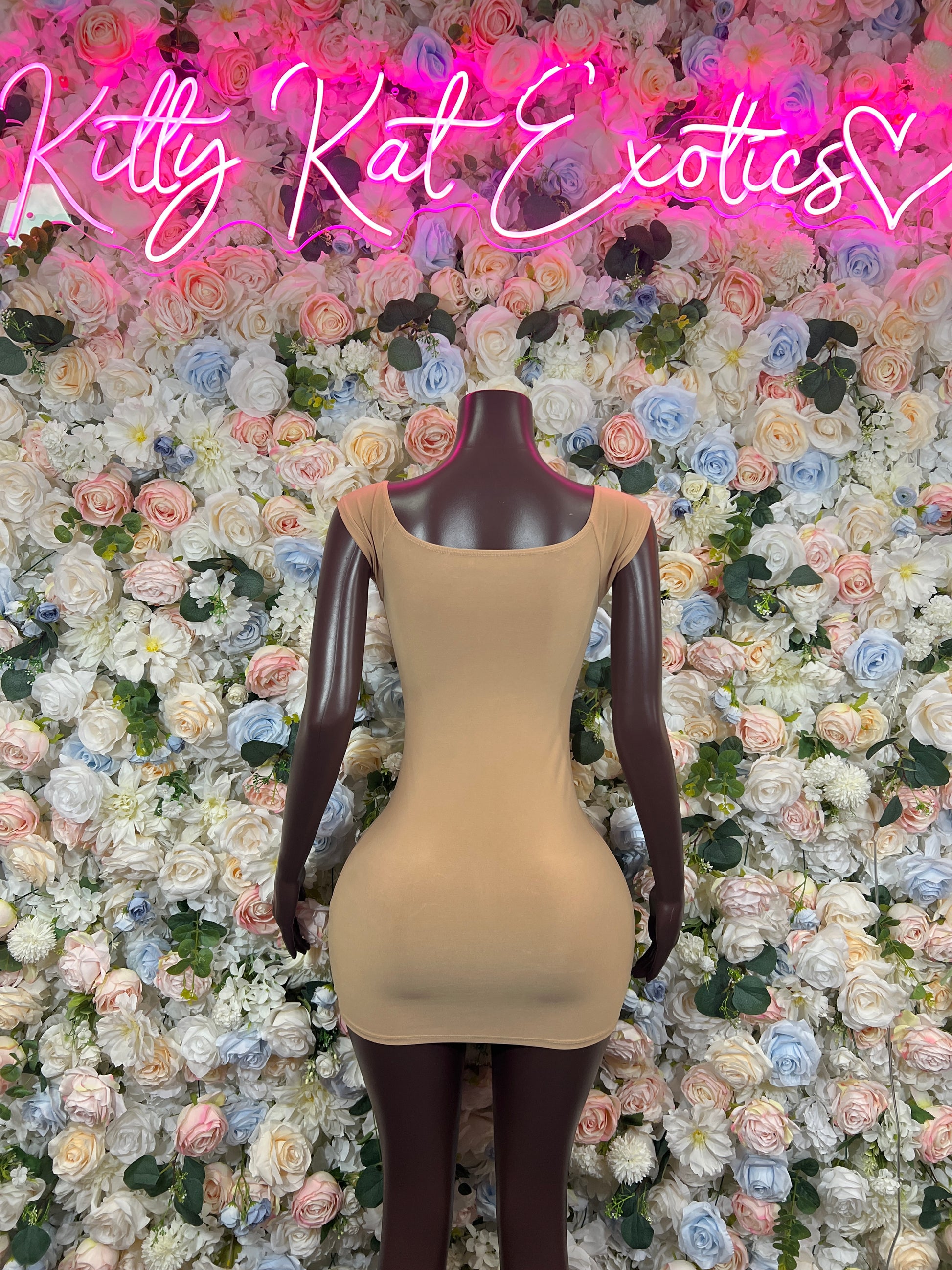 Nude sleeveless mini dress, fitted silhouette, scoop neck, corset-style front