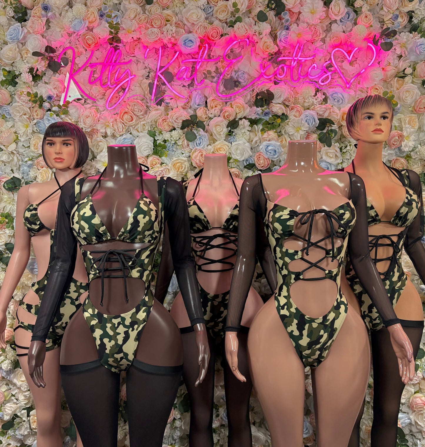 Group of camo print bodysuits with black mesh outer layers
