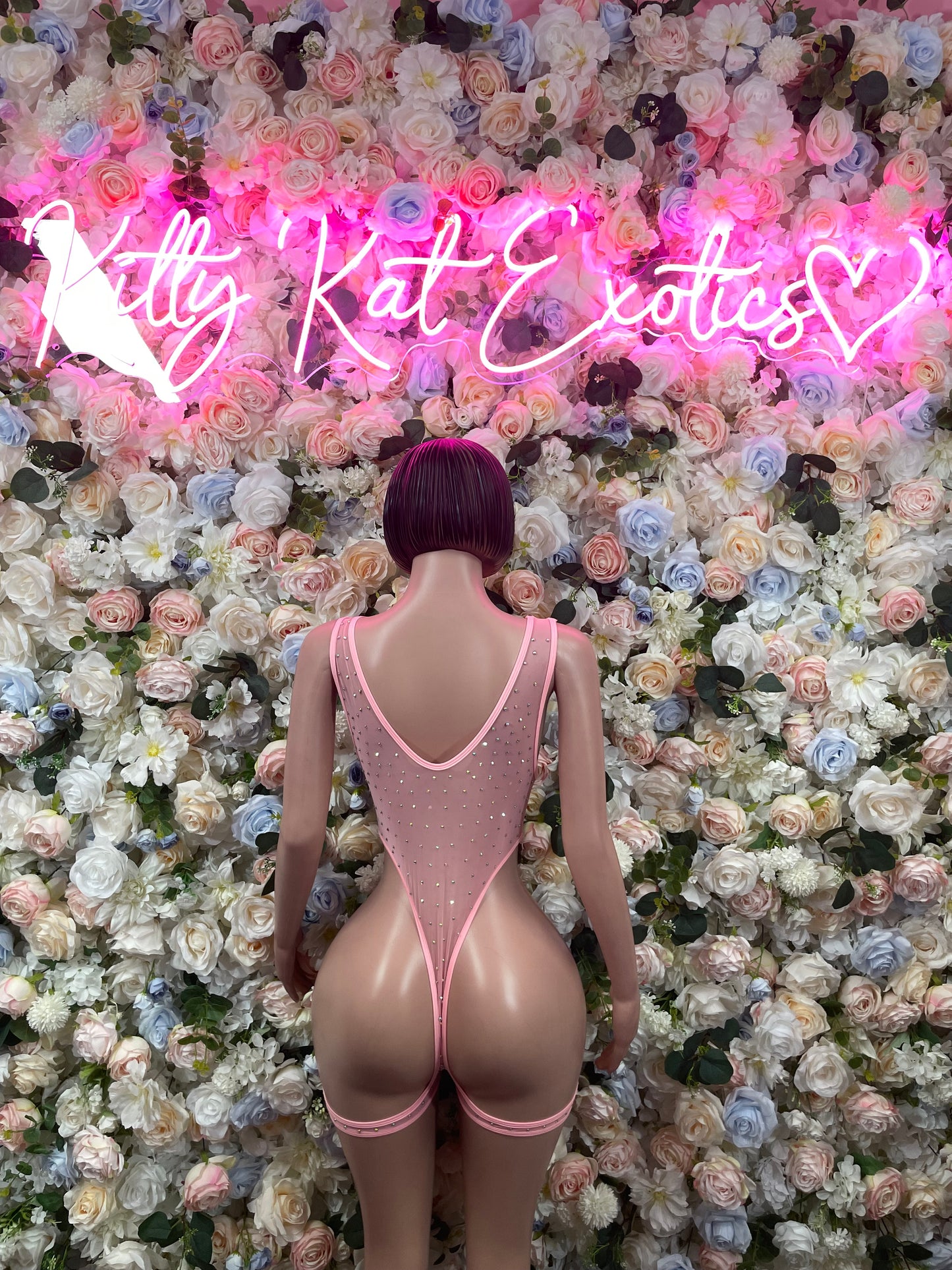 Back view pink rhinestone bodysuit with V-shaped cutout and thong style