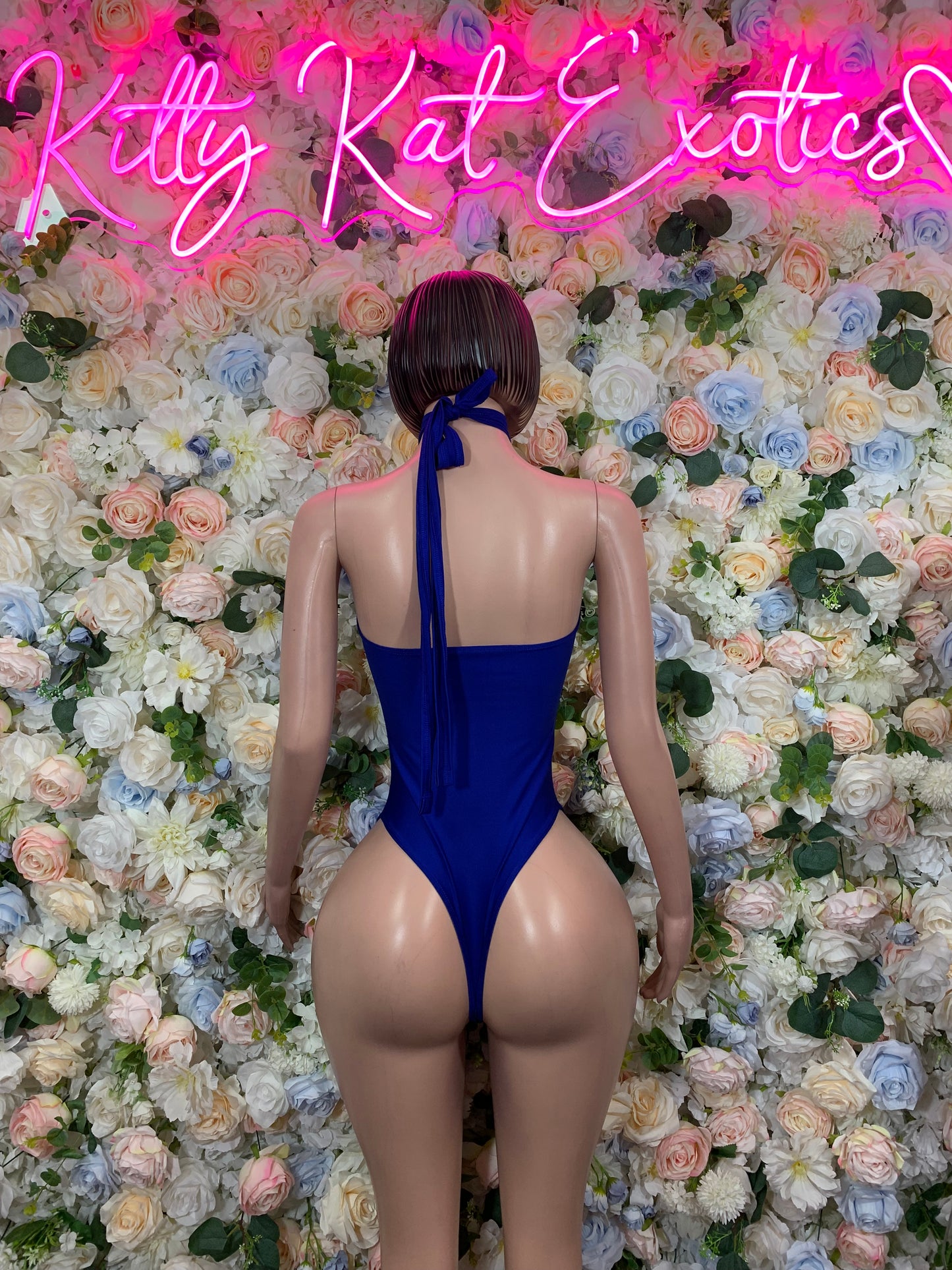 Blue one-piece bodysuit with open back and high-cut leg, sleeveless thong style