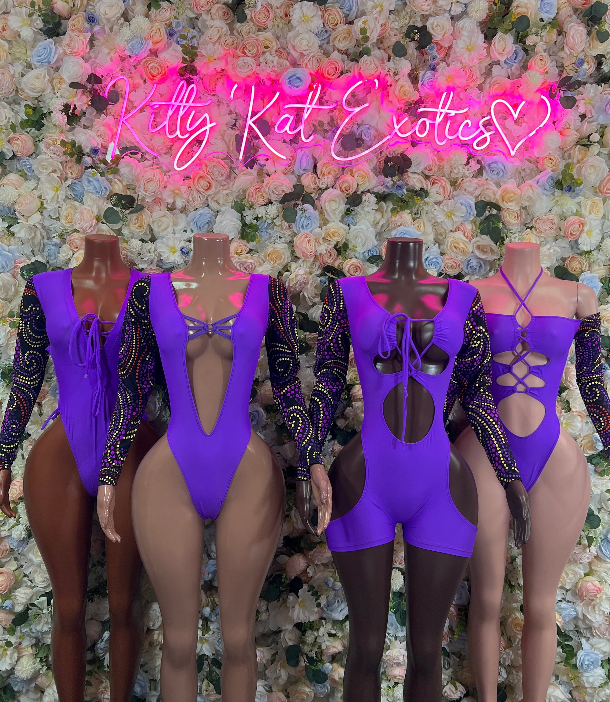 Purple long-sleeve bodysuits with black lace sleeves and back straps