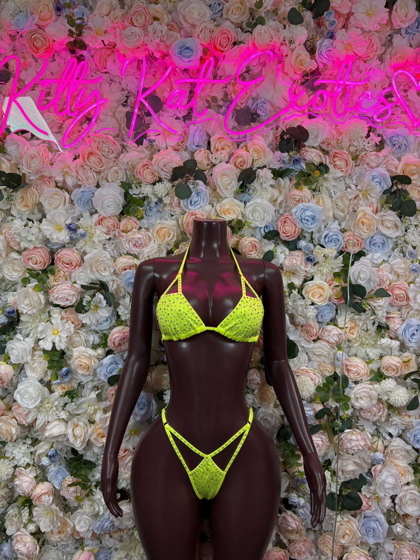 Neon green rhinestone triangle bikini set with strappy sides on a mannequin