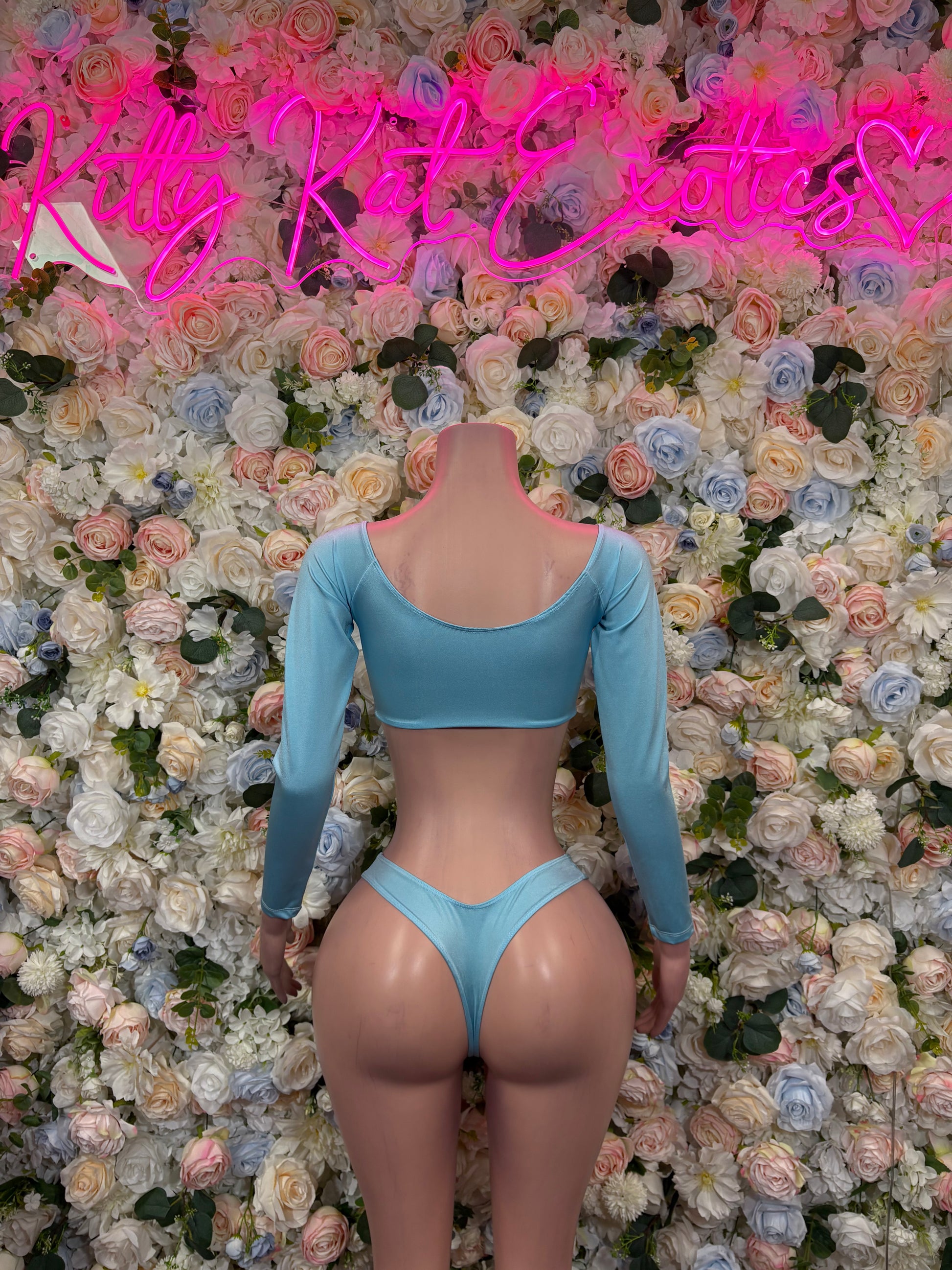 Light blue long-sleeve two-piece outfit with crisscross back straps and matching high-cut bottoms