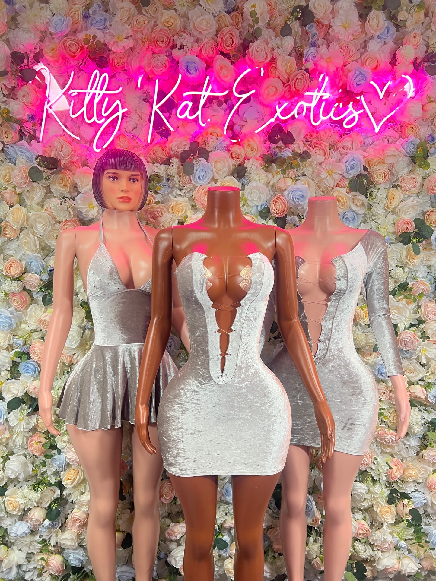 Silver velvet mini dress on mannequin with deep V front and long sleeves, fitted