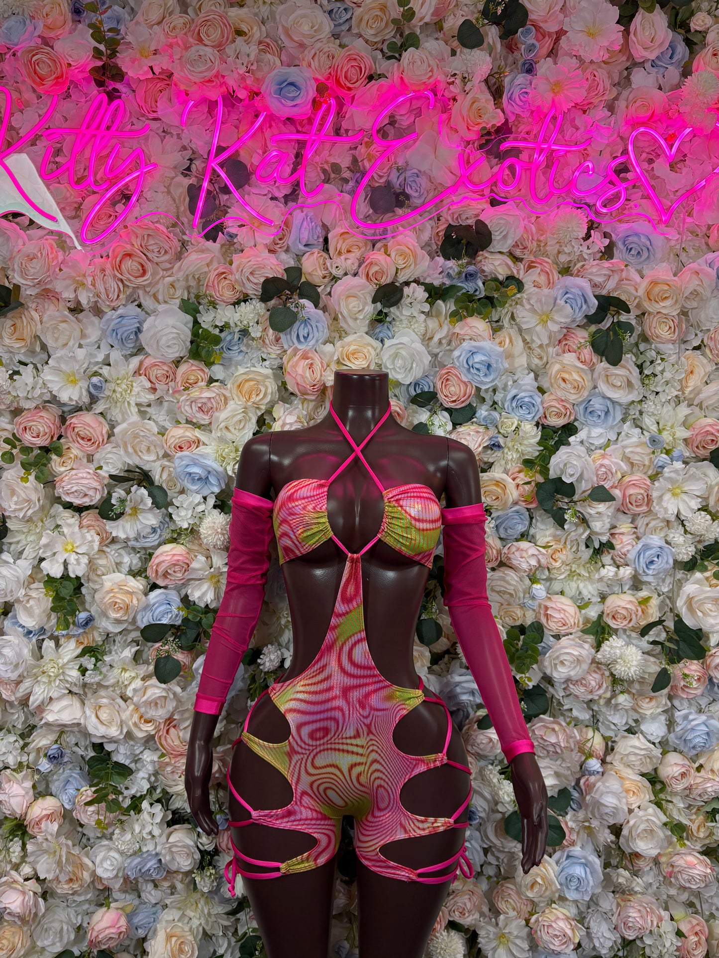 Pink and black holographic dance bodysuit with long sleeves and cutout sides