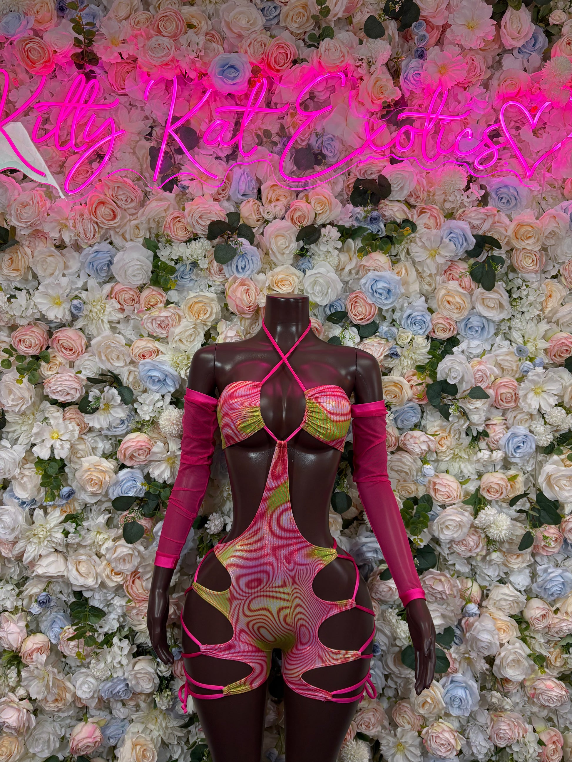 Pink and black holographic dance bodysuit with long sleeves and cutout sides
