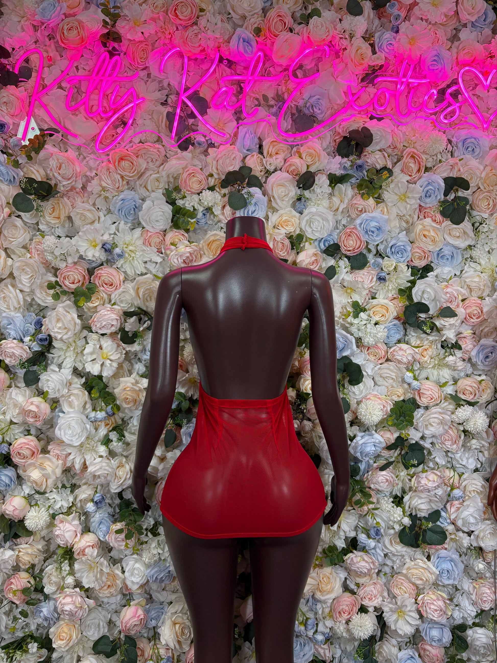 Red halter bodycon mini dress, back view with low-back design.