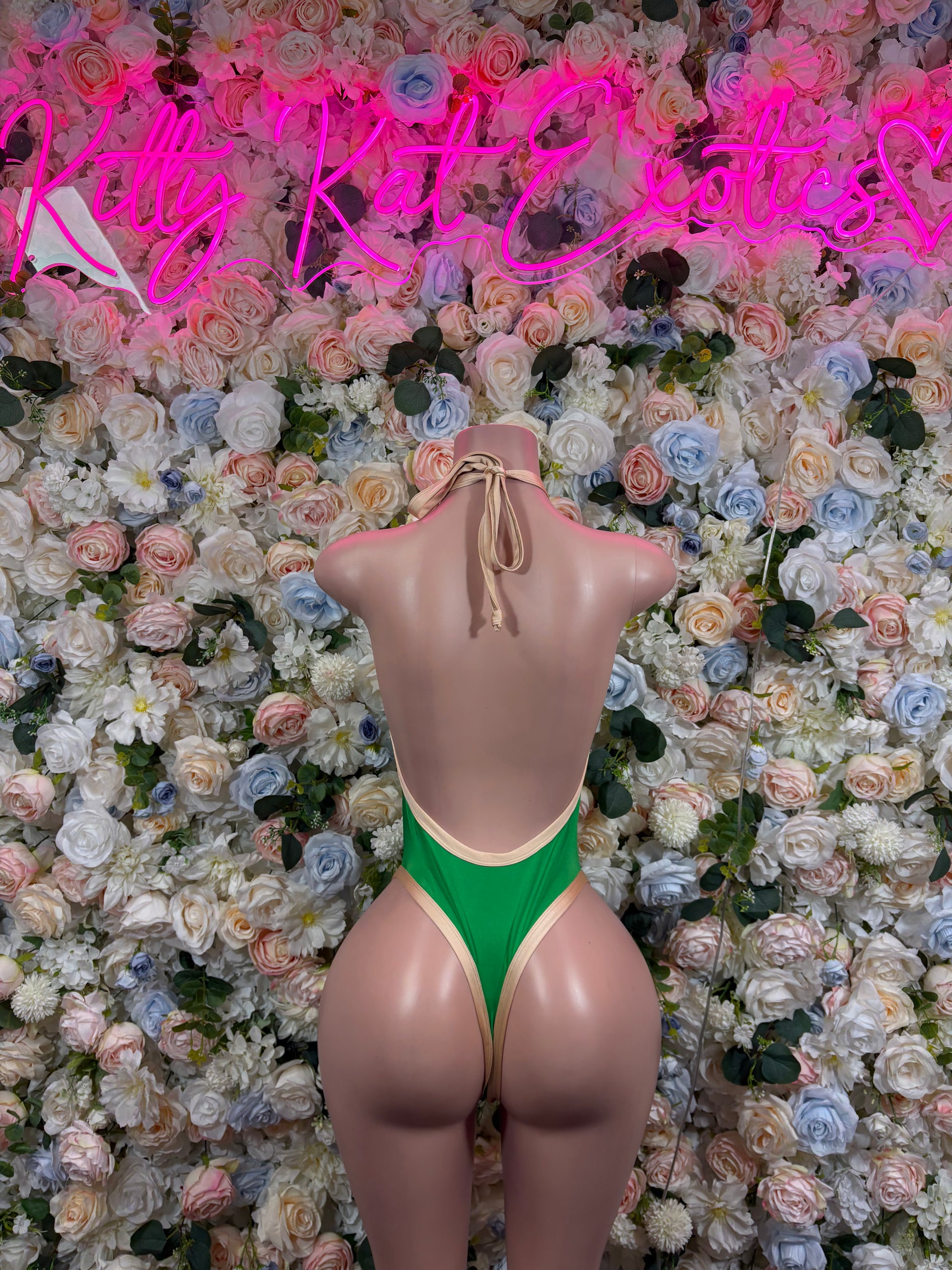 Green one-piece bodysuit back view with tied halter straps